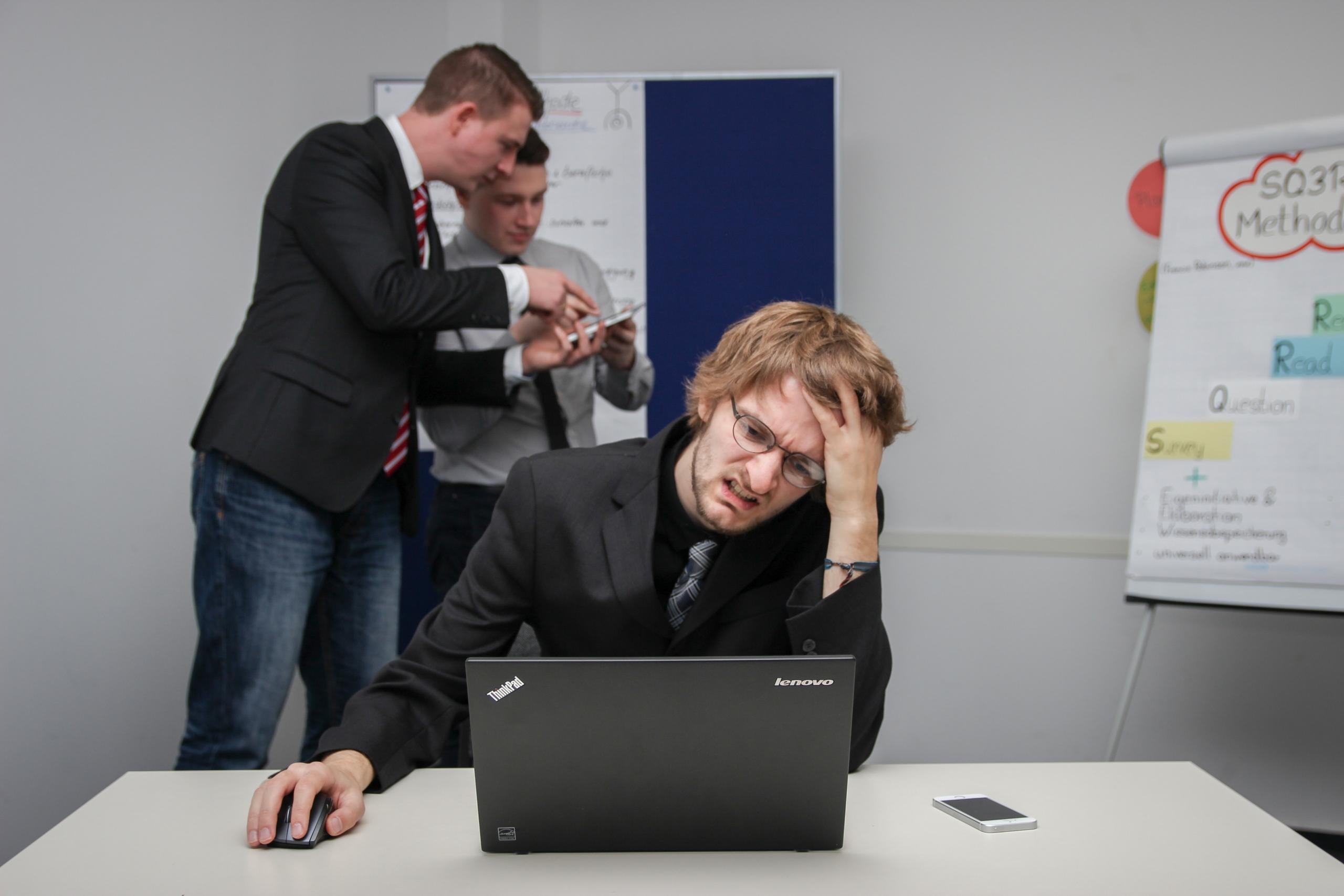 stressed man on a laptop