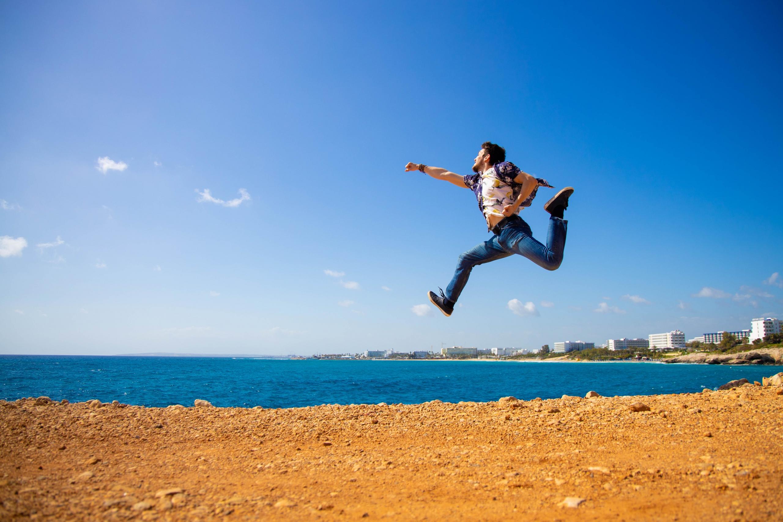 man jumping in superman pose