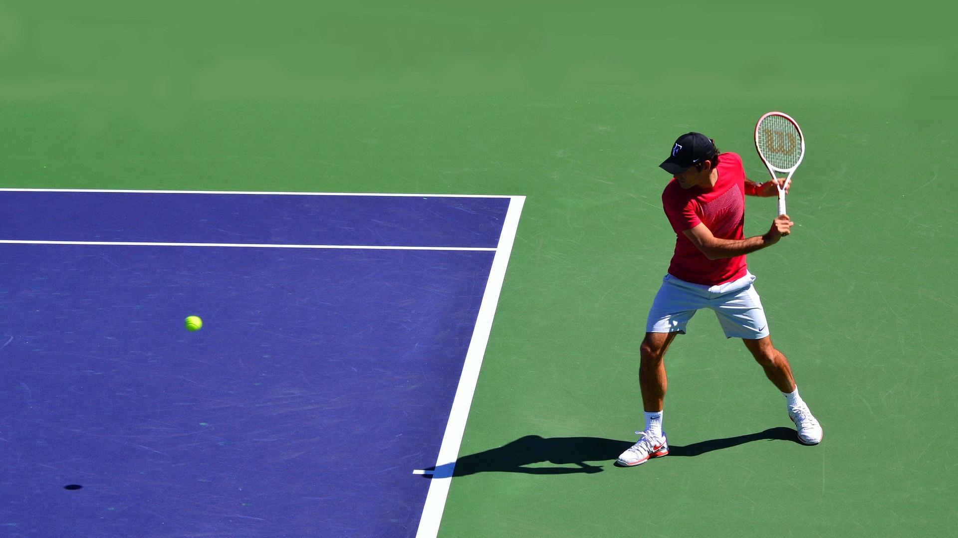The Swiss wizard, Roger Federer, is about to hit the ball on the court