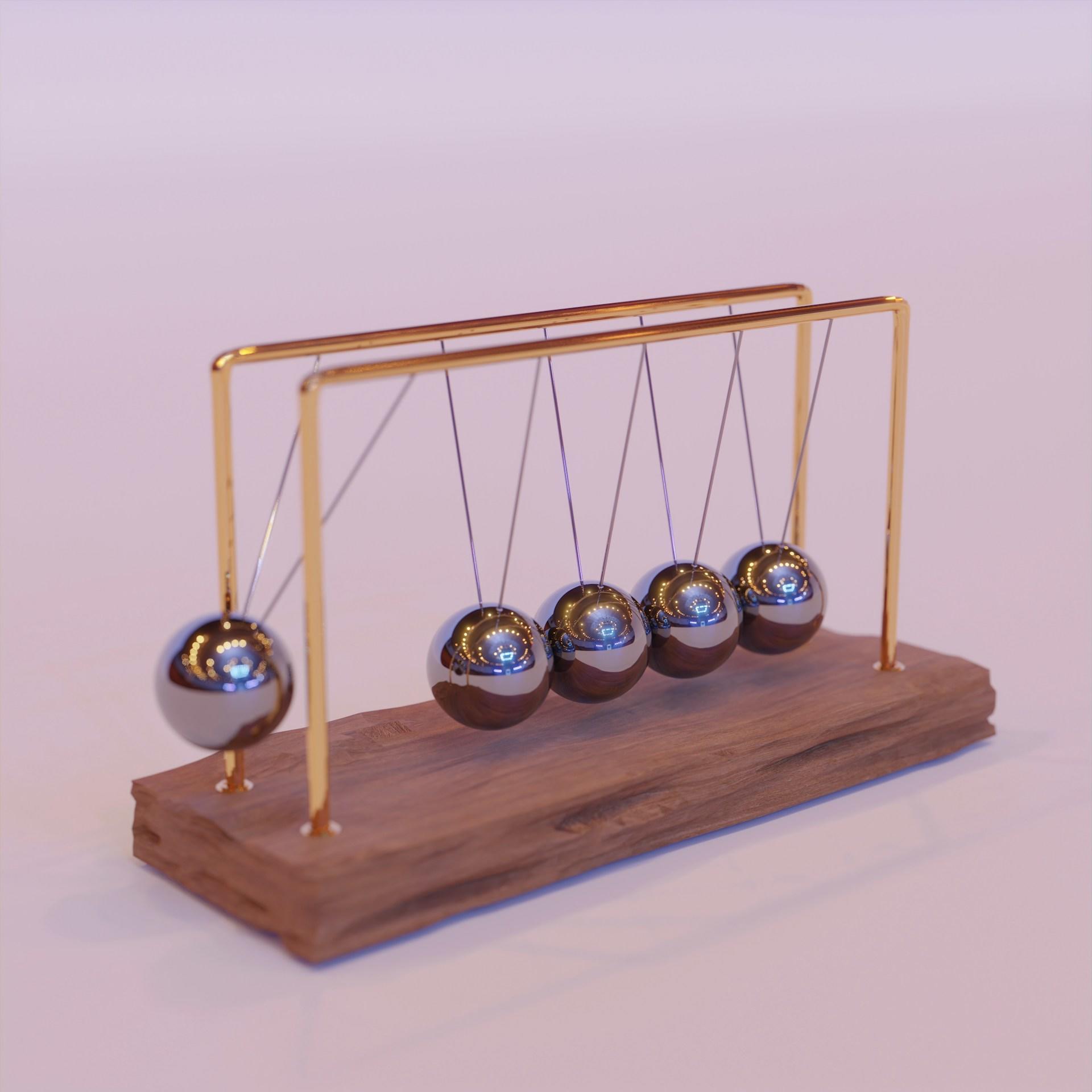 A Newton's cradle with balls suspended, demonstrating the conservation of momentum and energy.