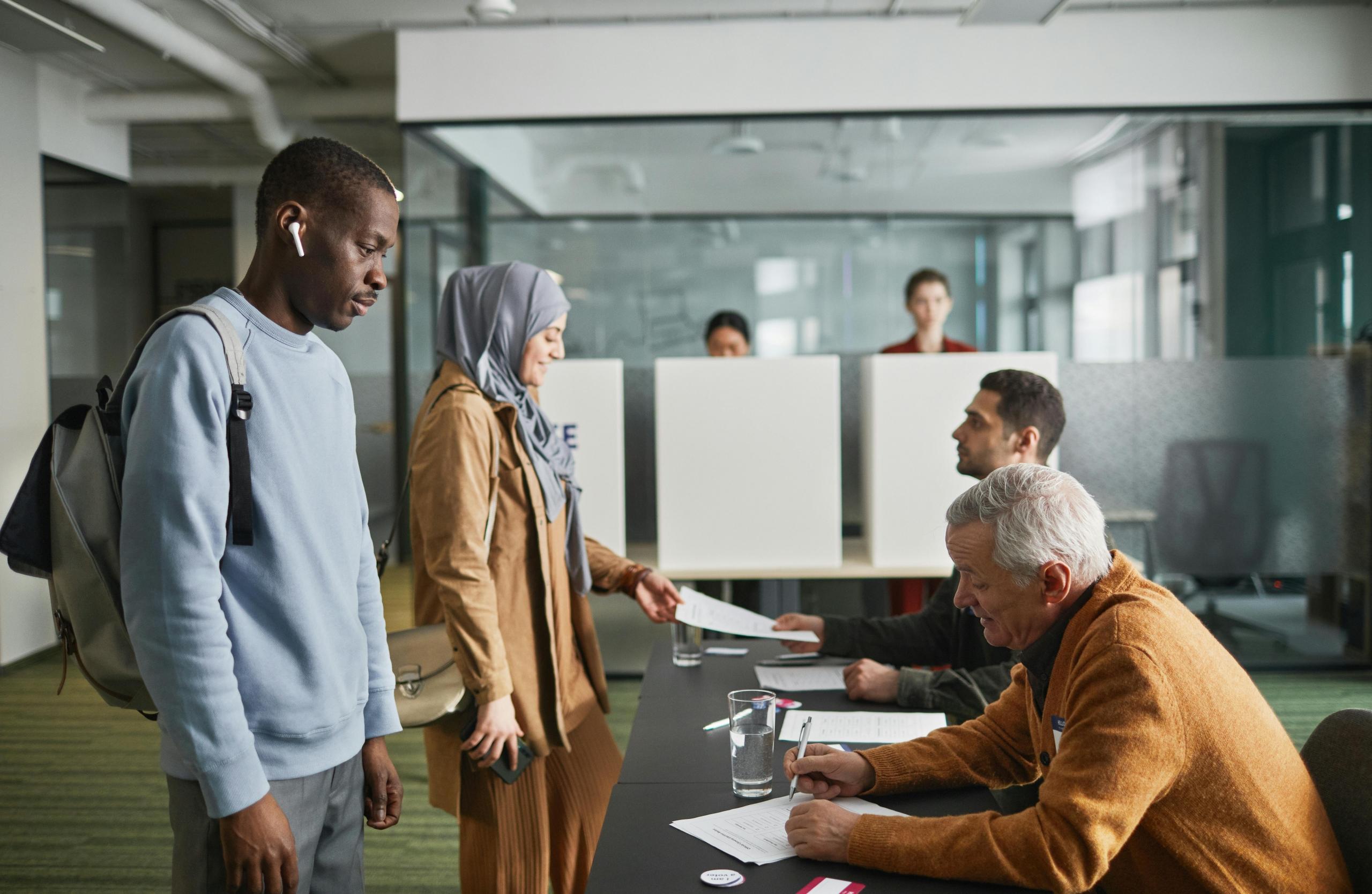 Two members of a community cast their votes in the local elections.