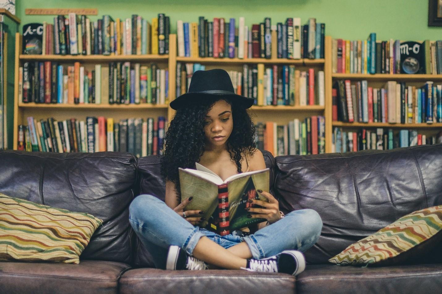 A woman in a library reading a book
