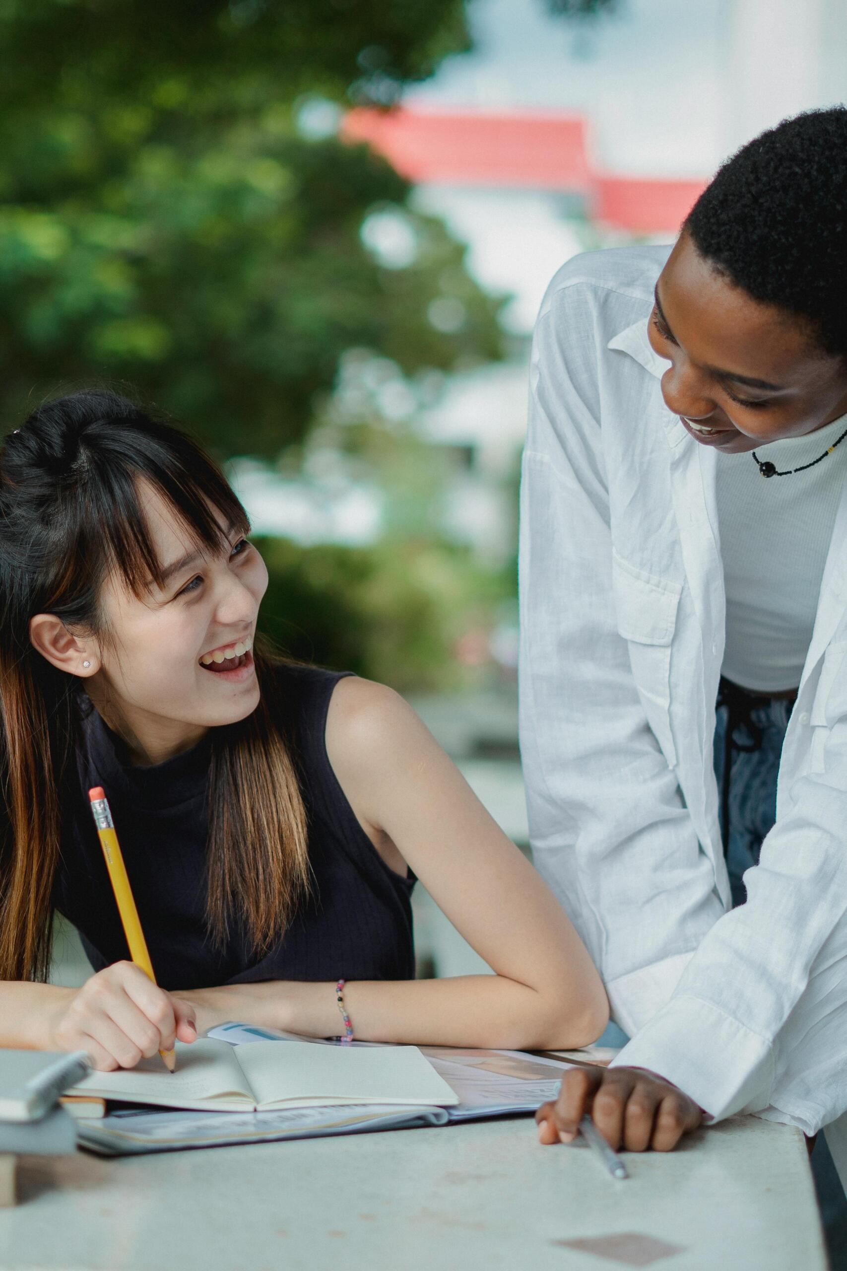 Female friends preparing for an exam outside