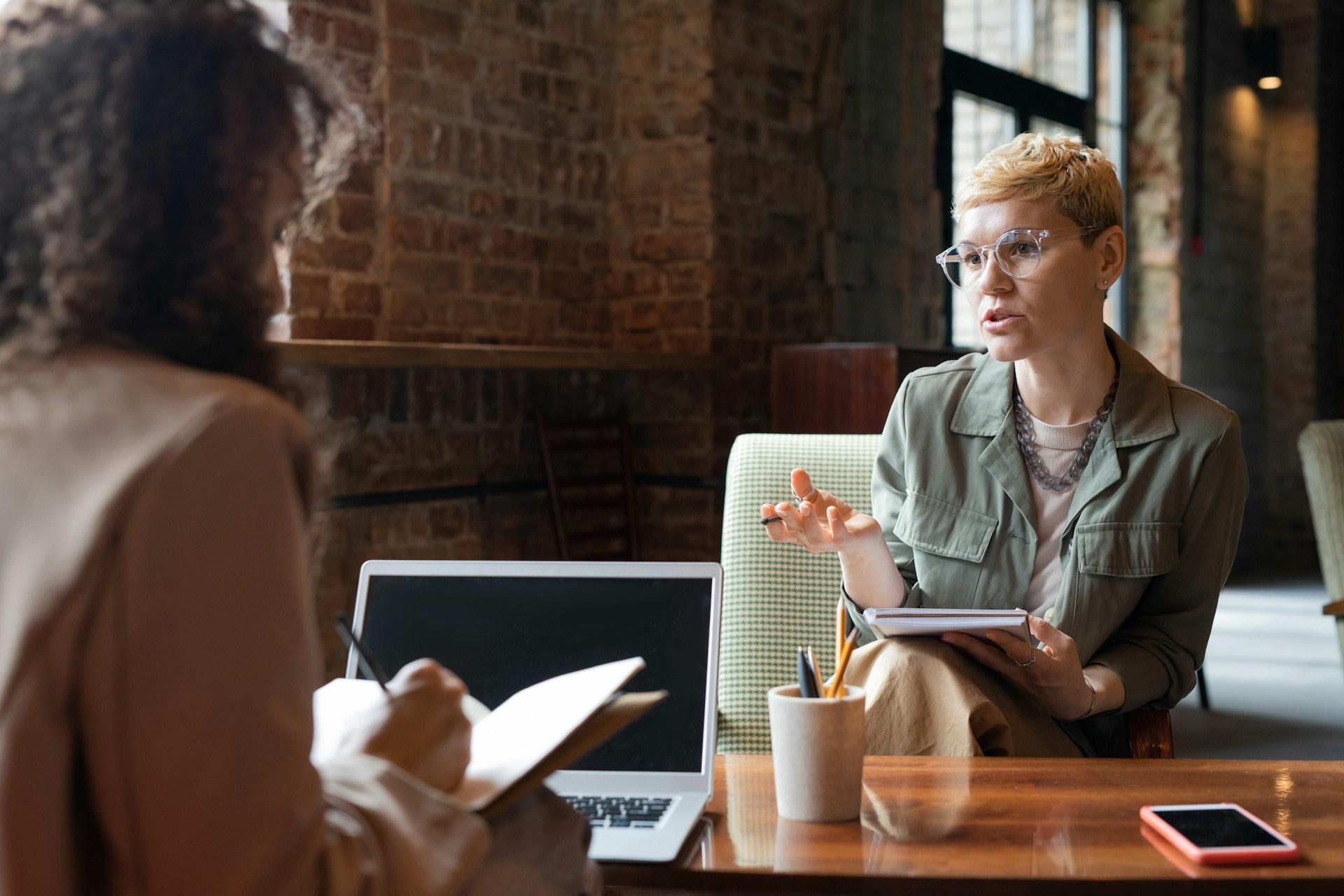 two women discussing over the computer 