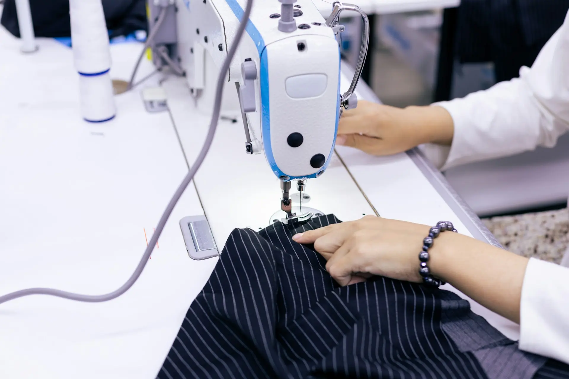 a person using a sewing machine
