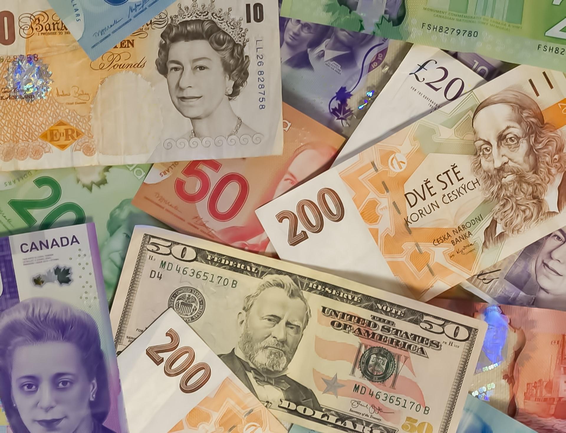 Assorted world currencies with the pound sterling in the upper left-hand corner