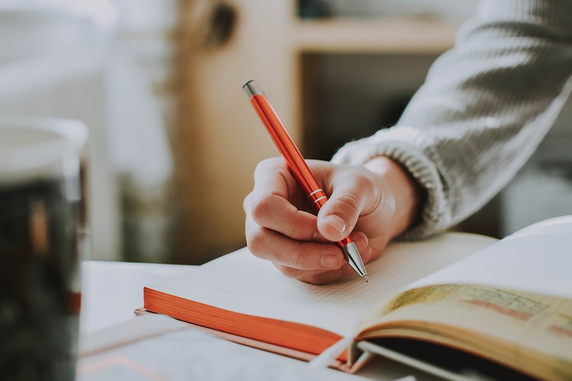 A man taking notes in a notebook.