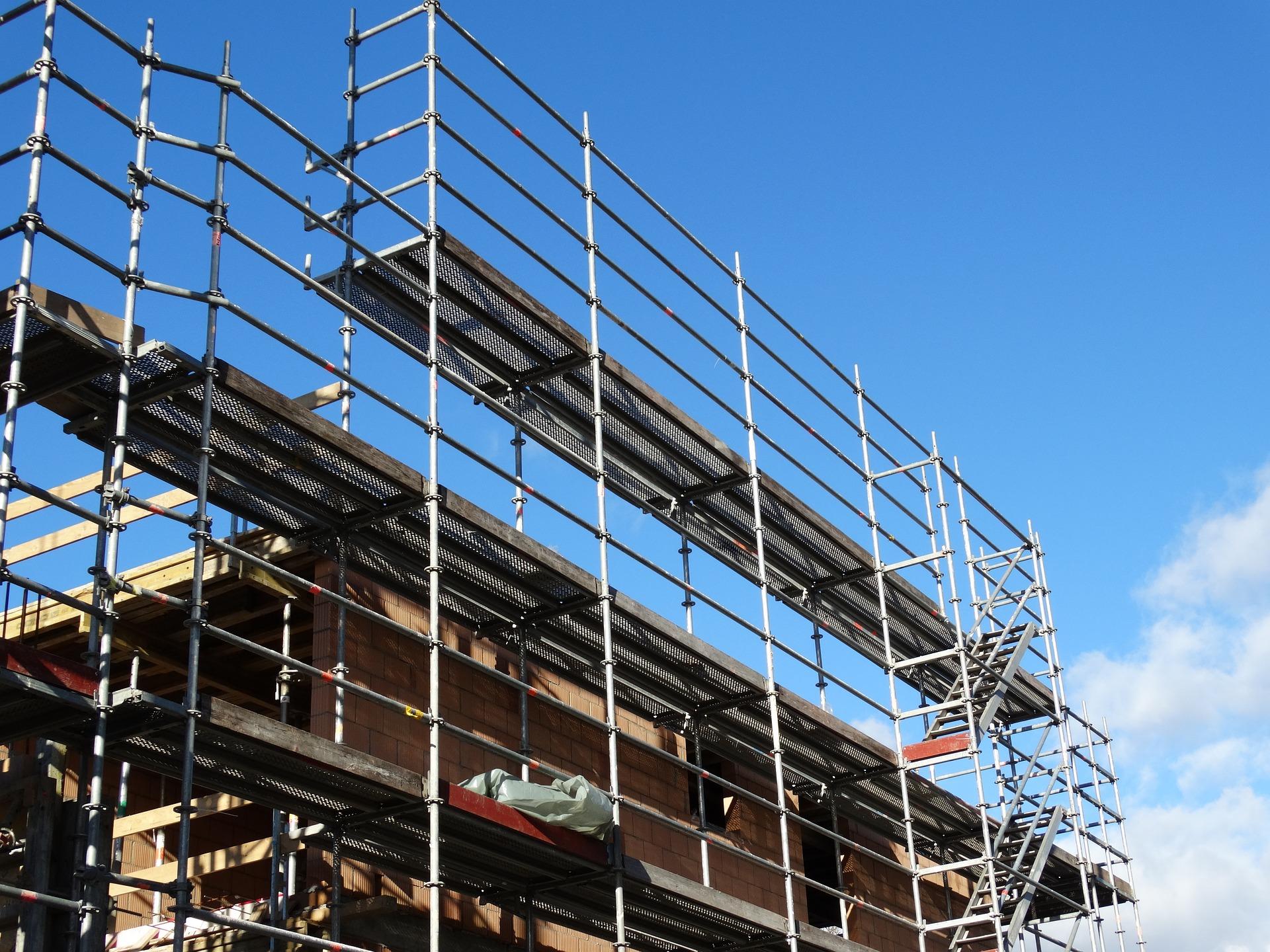 A house being built with scaffolding on the outside.