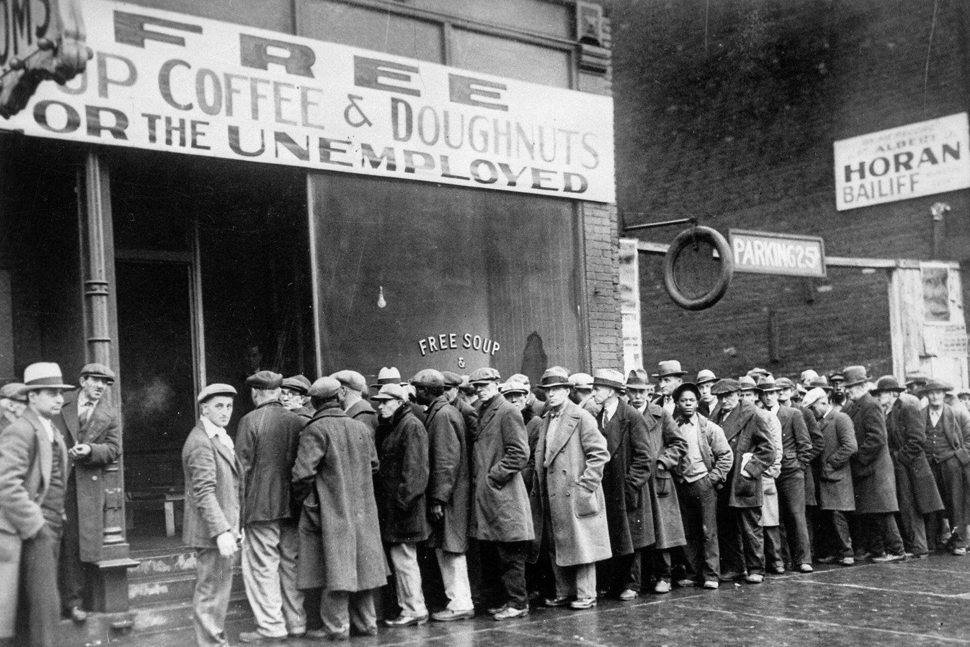 Unemployed men queuing up outside a soup kitchen during the Great Depression.