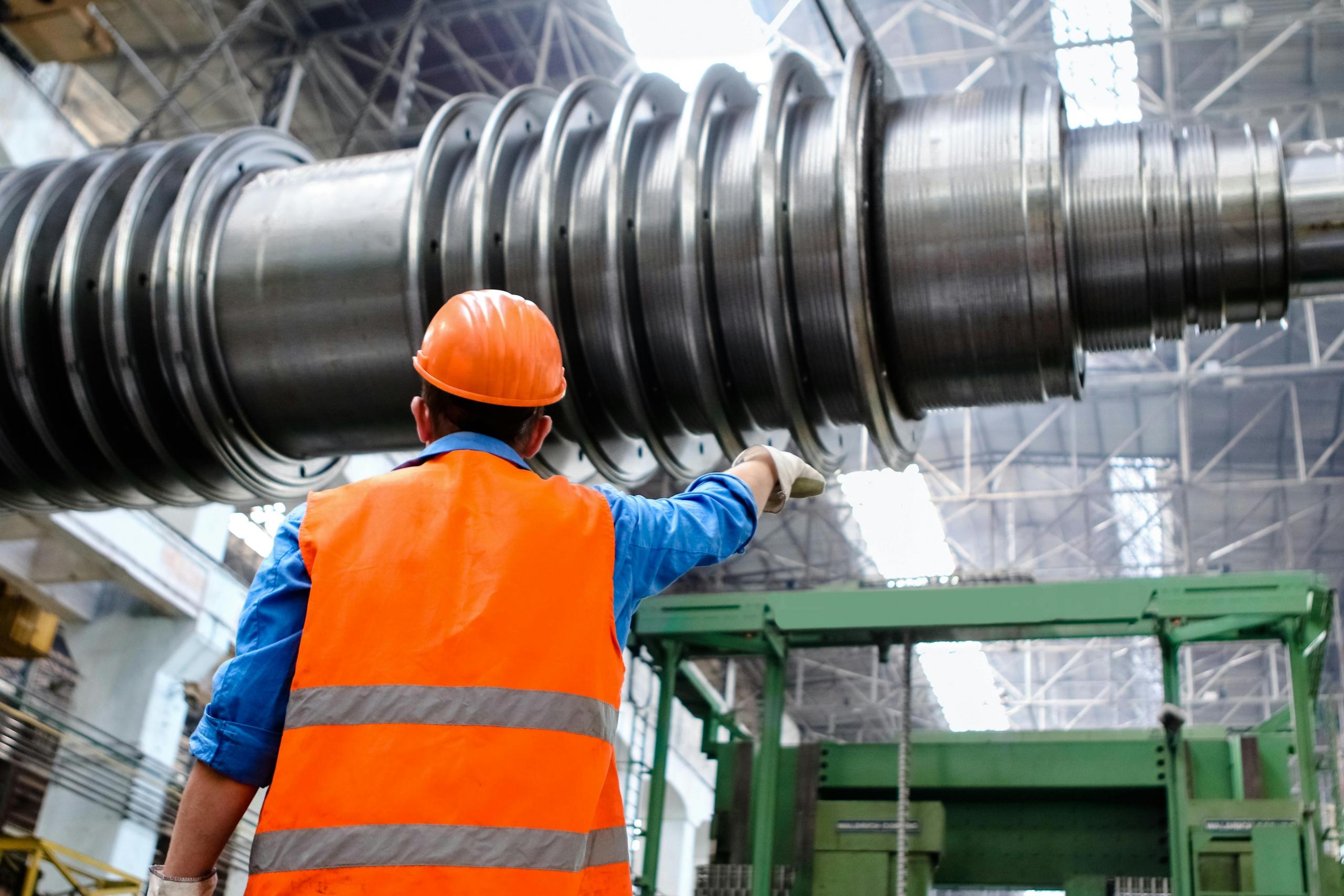 An engineer following plans that have been created from a series of maths calculations