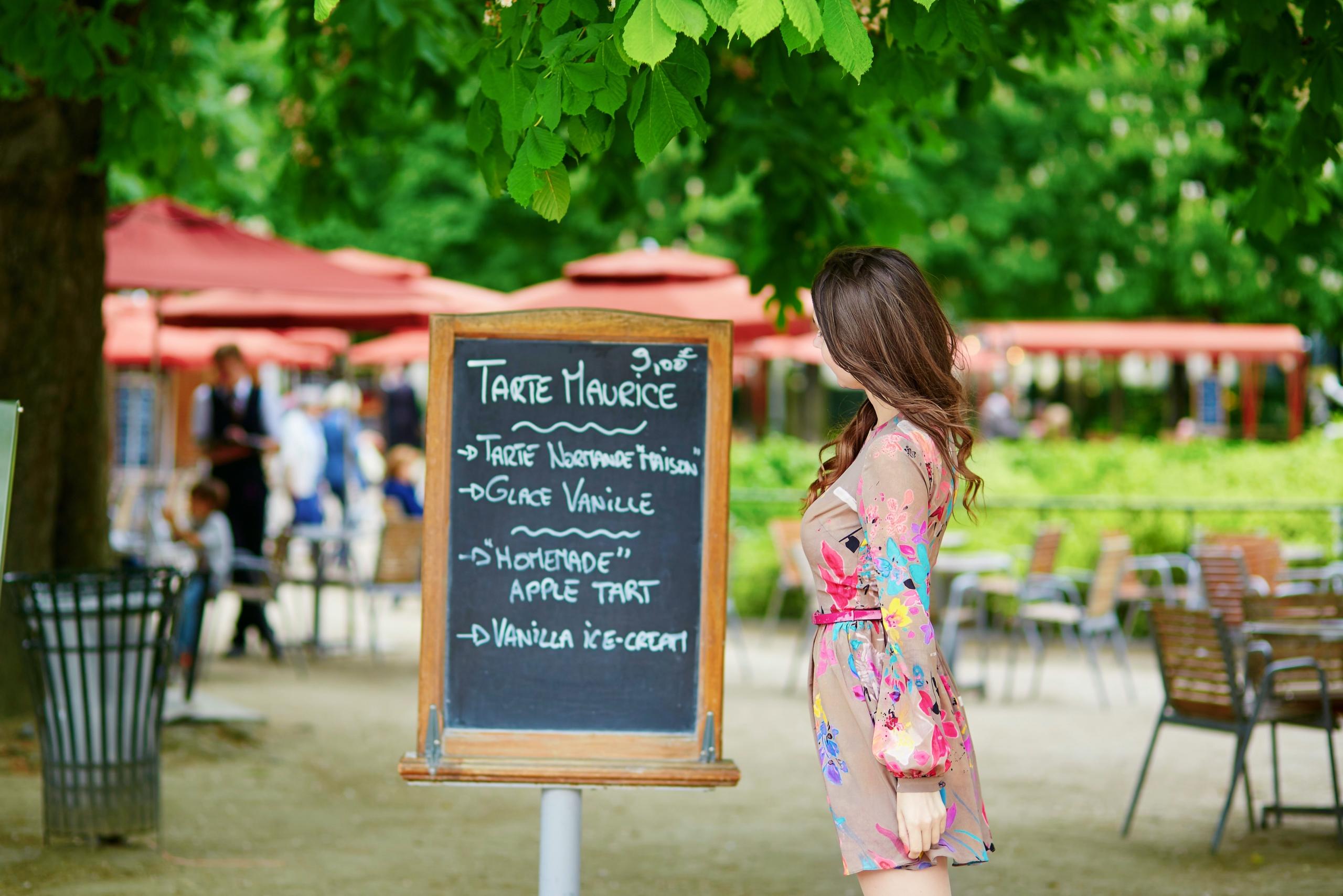 Woman in front of menu in french
