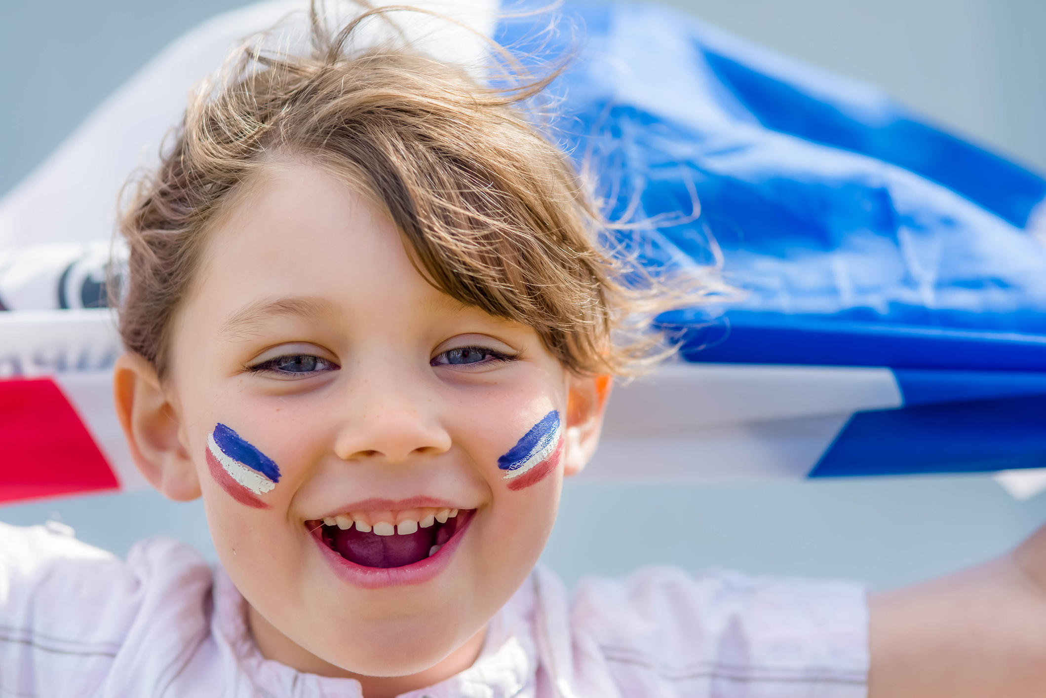 Girl with french flag painted on her face