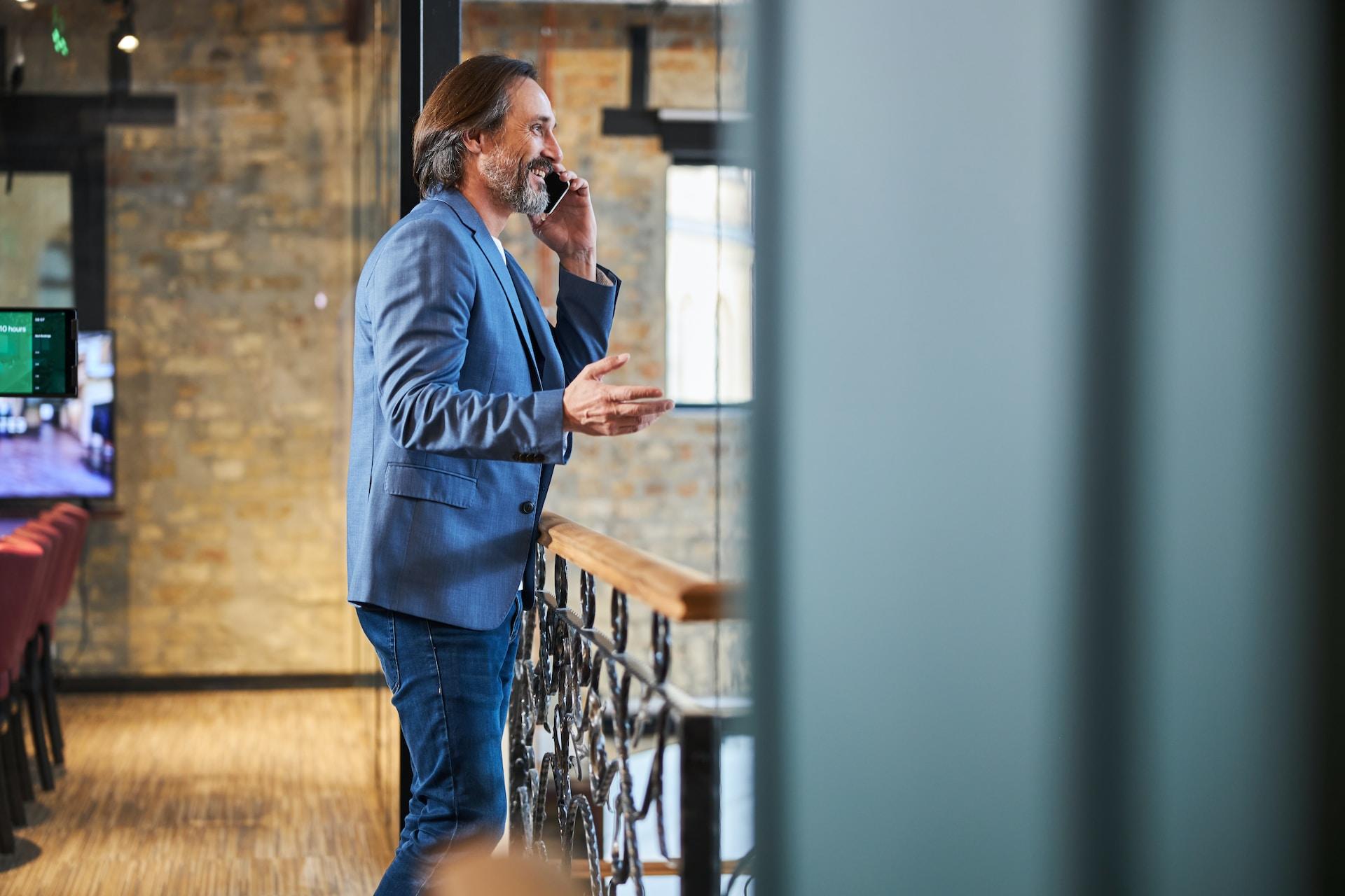 Man in suit talking on his phone.