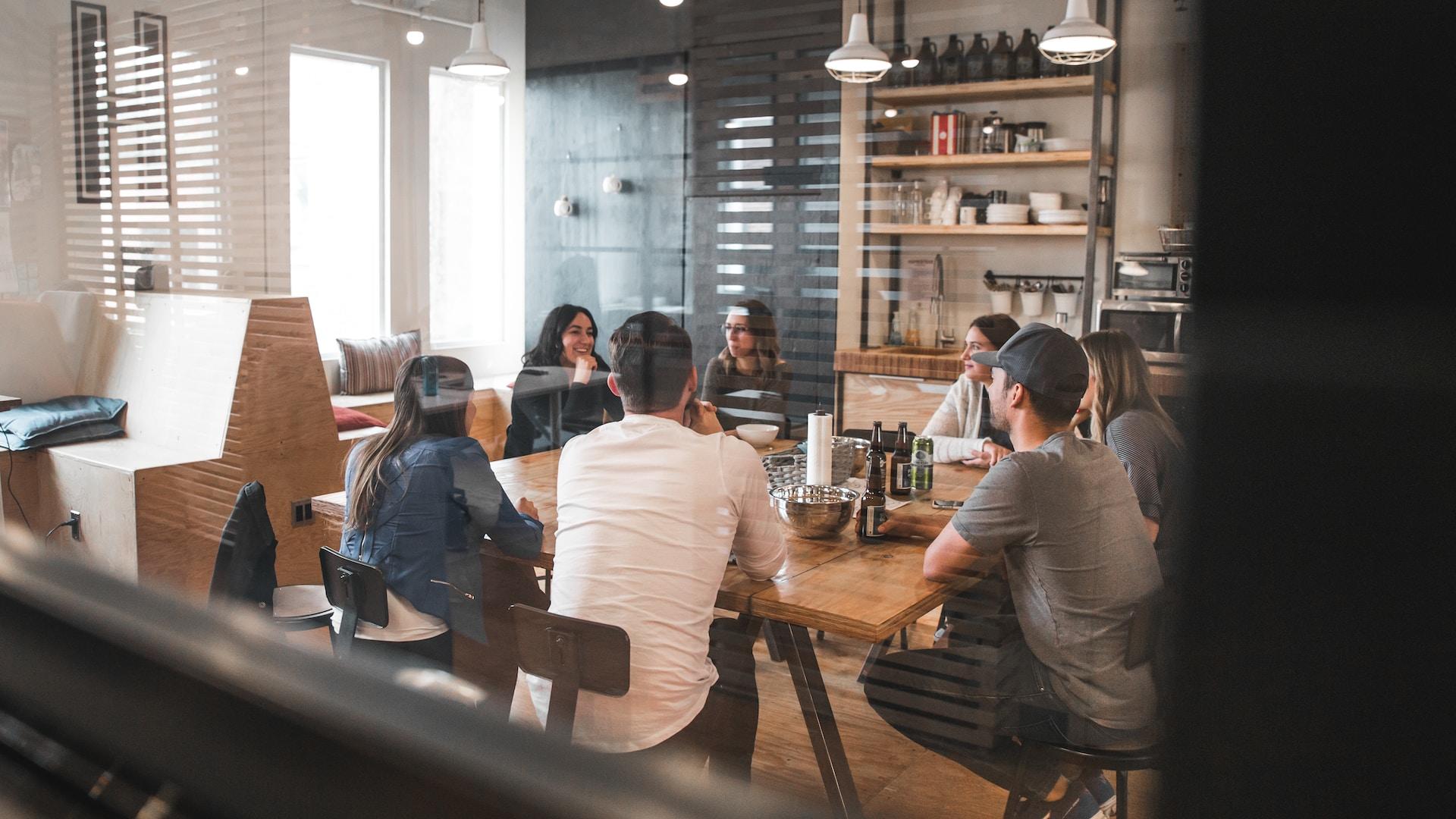 Colleagues around a table in the office kitchen.