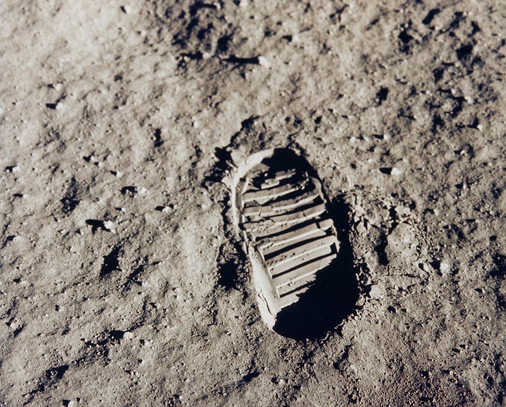 A greyscale image of the first human footprint on the moon.