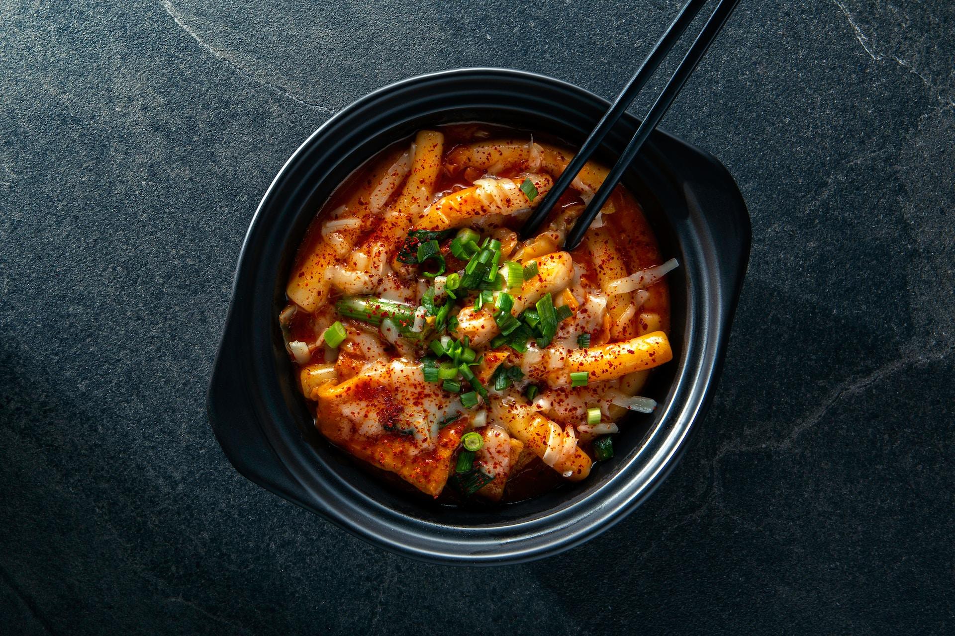 A bowl of tteokbokki, a spicy Korean dish.