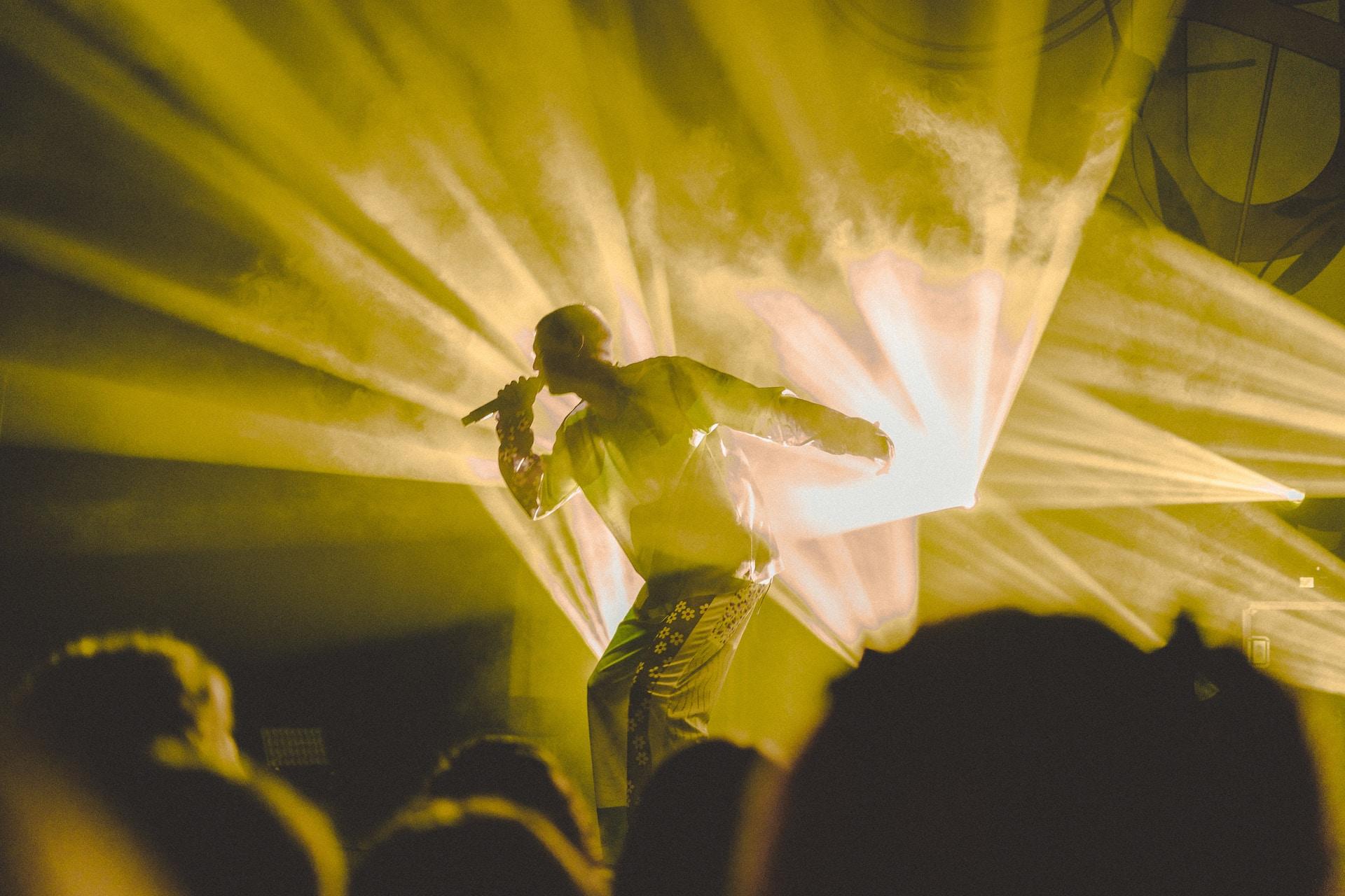 A man singing on stage.
