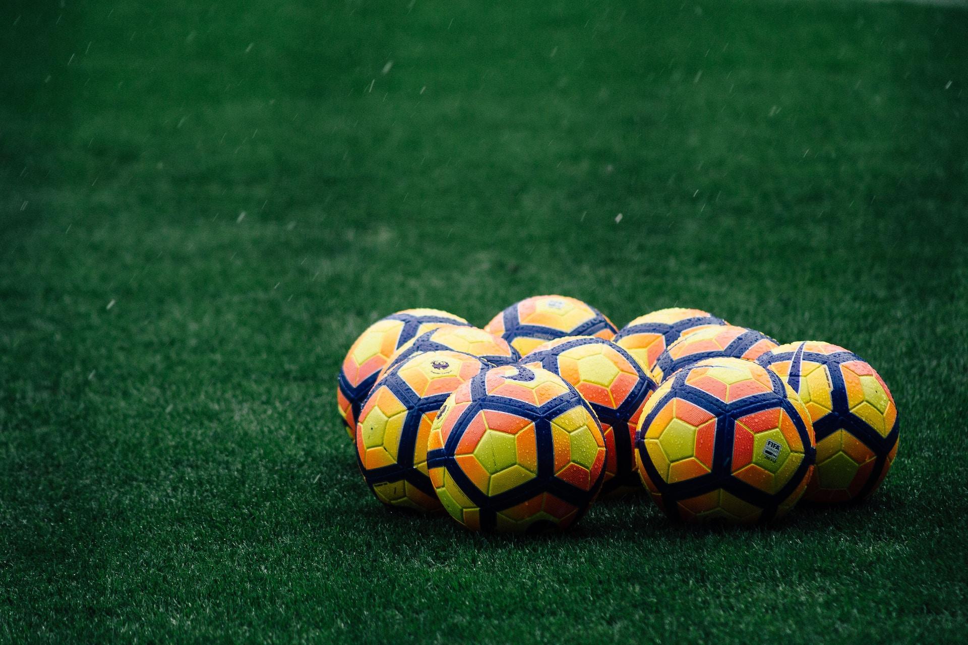 Several yellow Nike soccer balls.