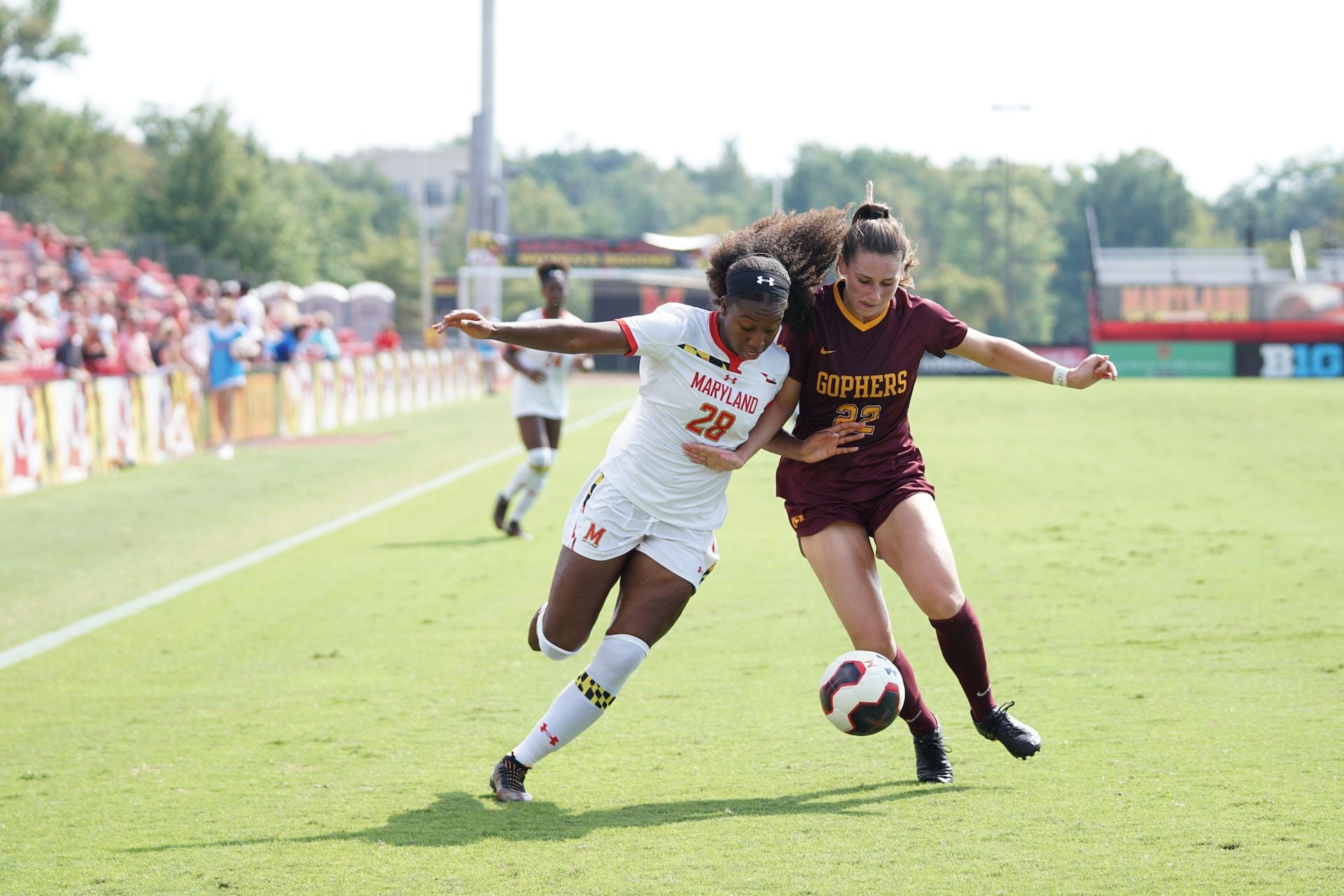 Women playing in a soccer match.