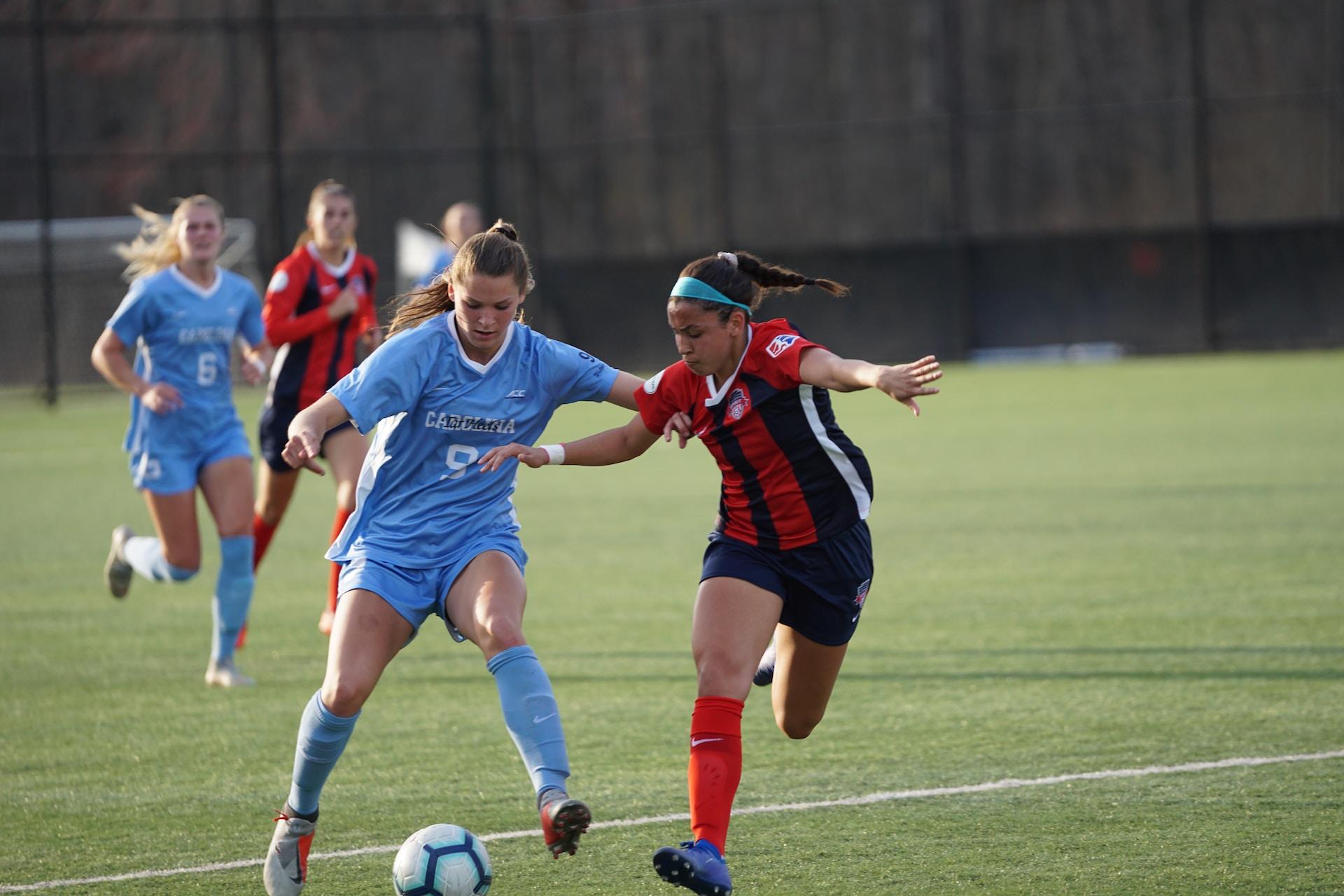 Women in the middle of a soccer match.