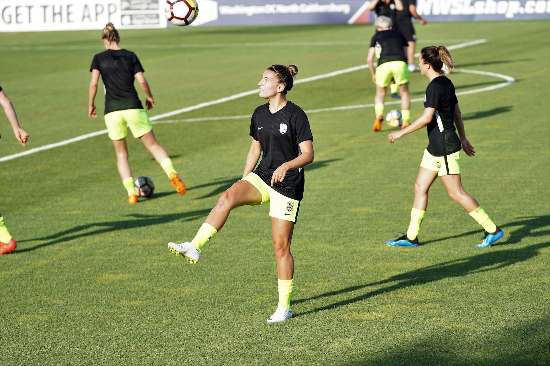 A female soccer player warming up before a match.