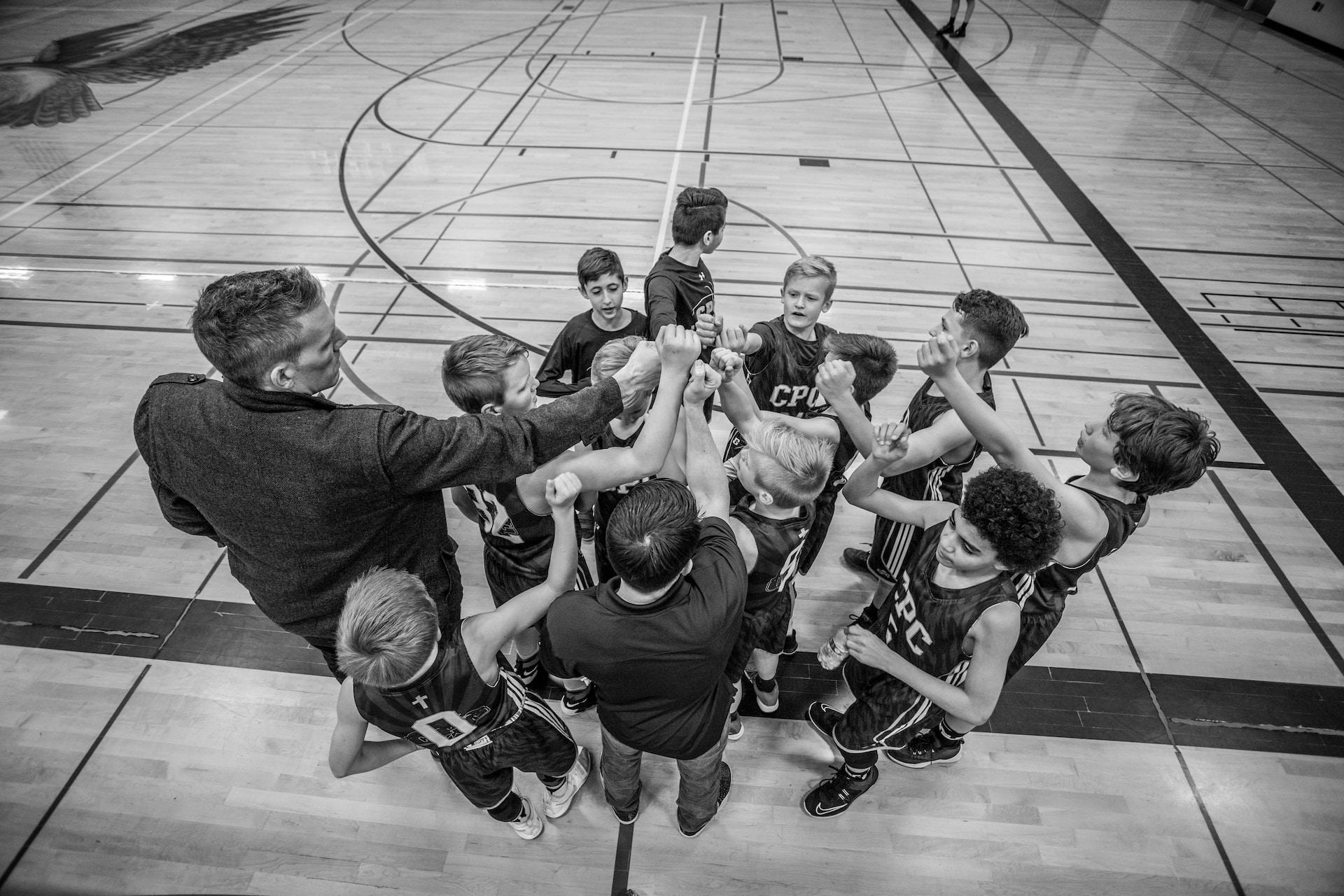 A basketball coach working with children.