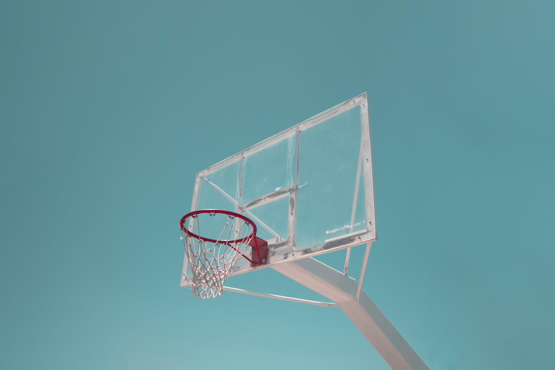 A basketball hoop against a blue sky.