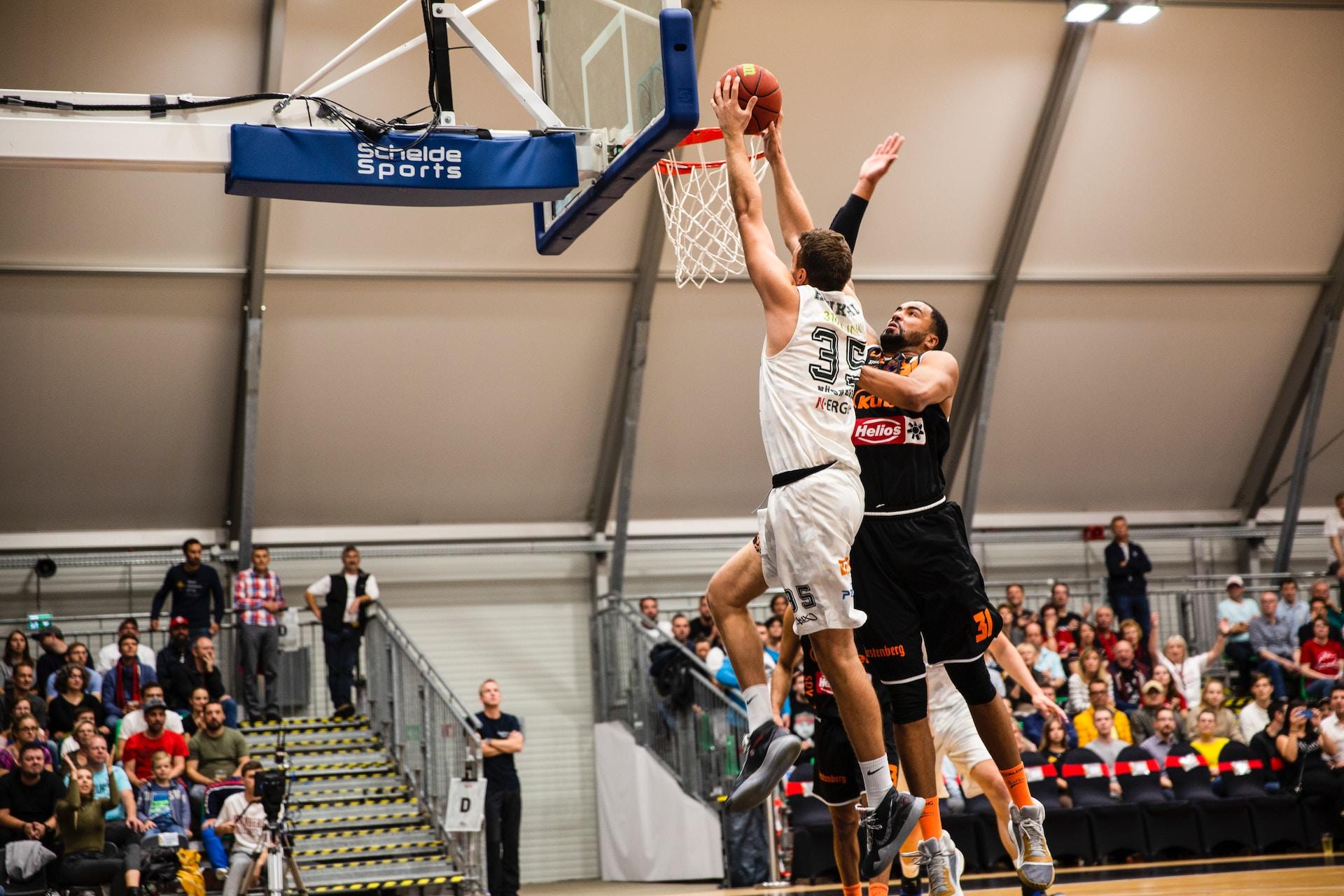 A basketball player dunking the ball.