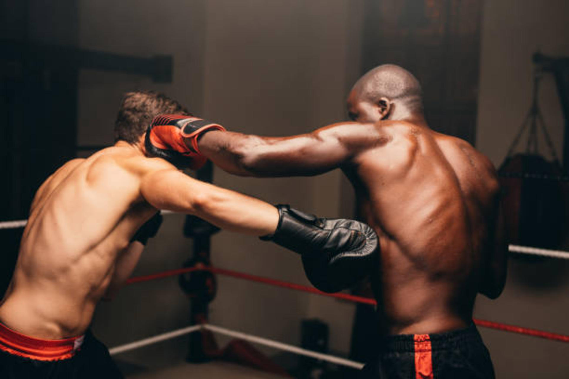 Two boxers throwing punches during a fight.