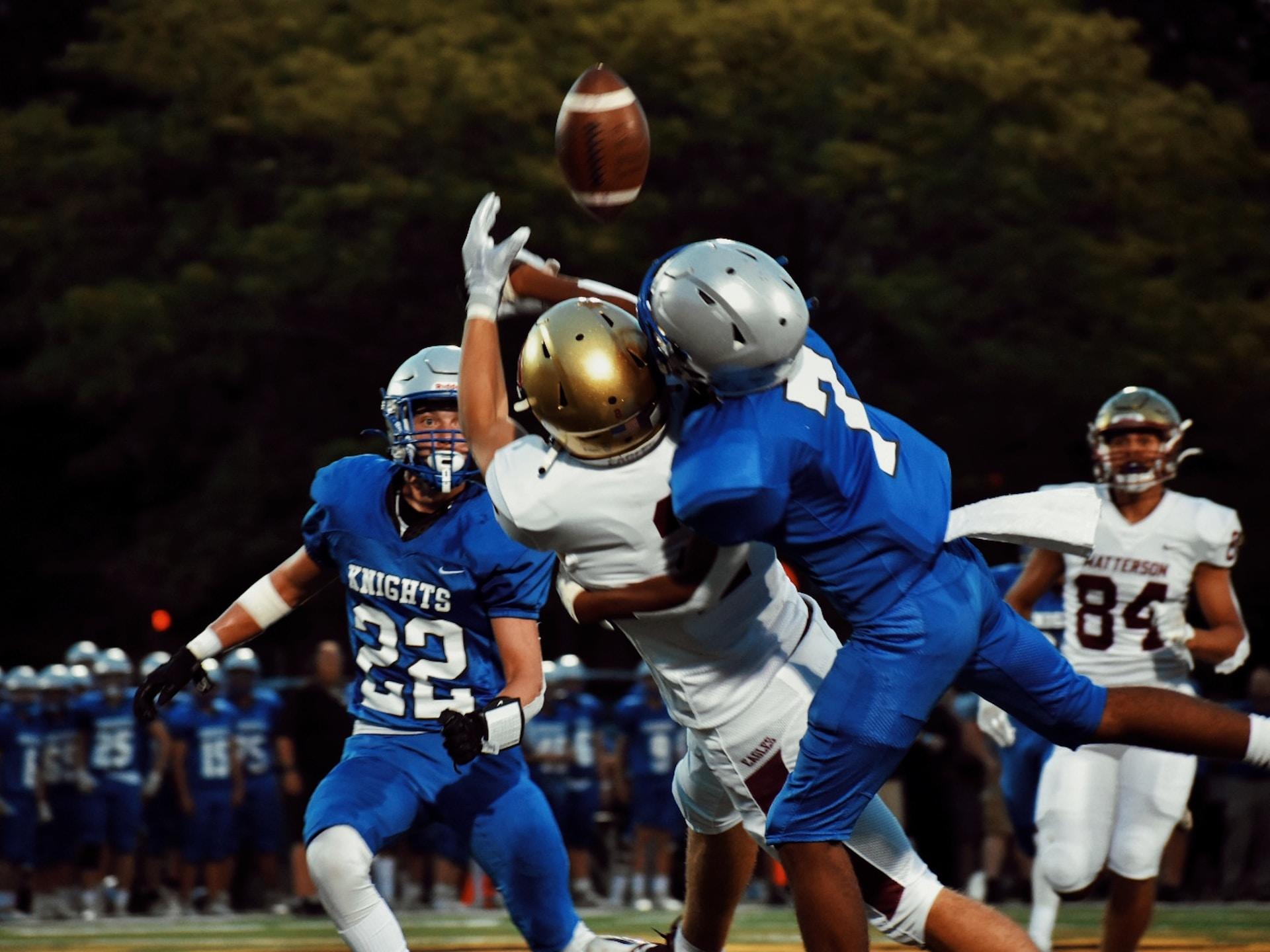 two football players trying to catch the ball