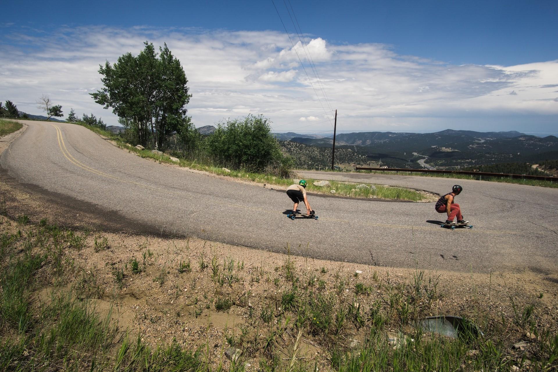 Longboarders going down a hill.