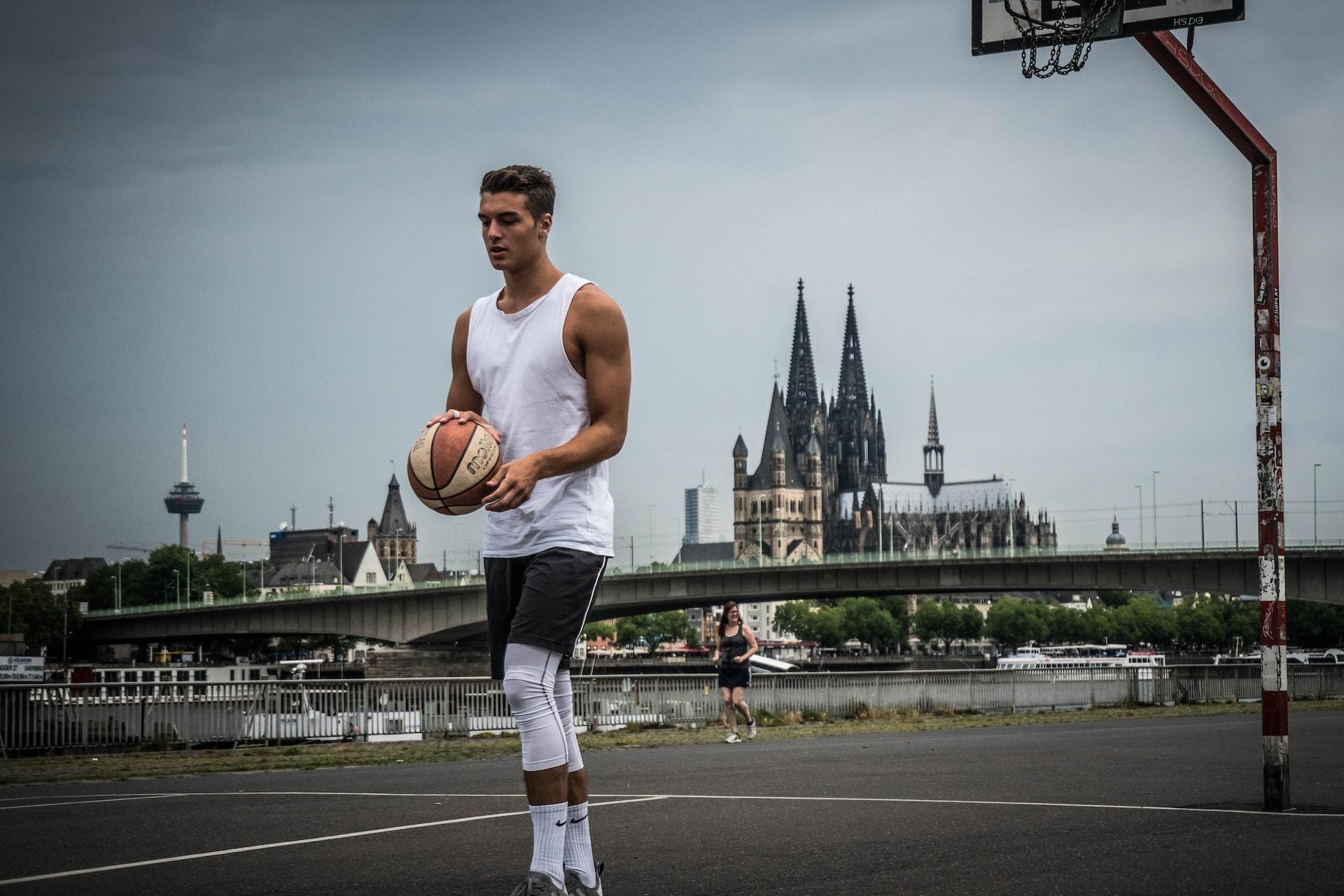 A man practising basketball.
