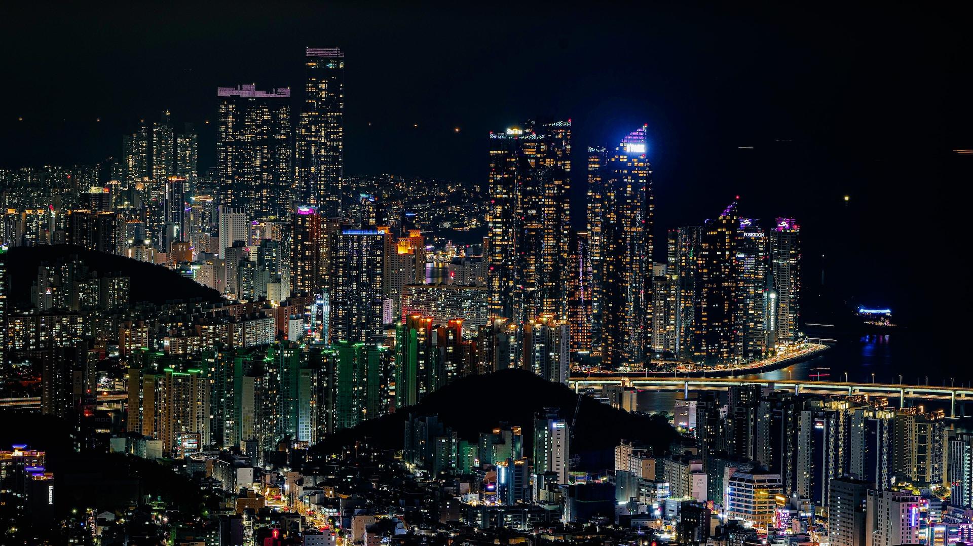 A crisp view of Busan at night, all lit up, seen from across the water.