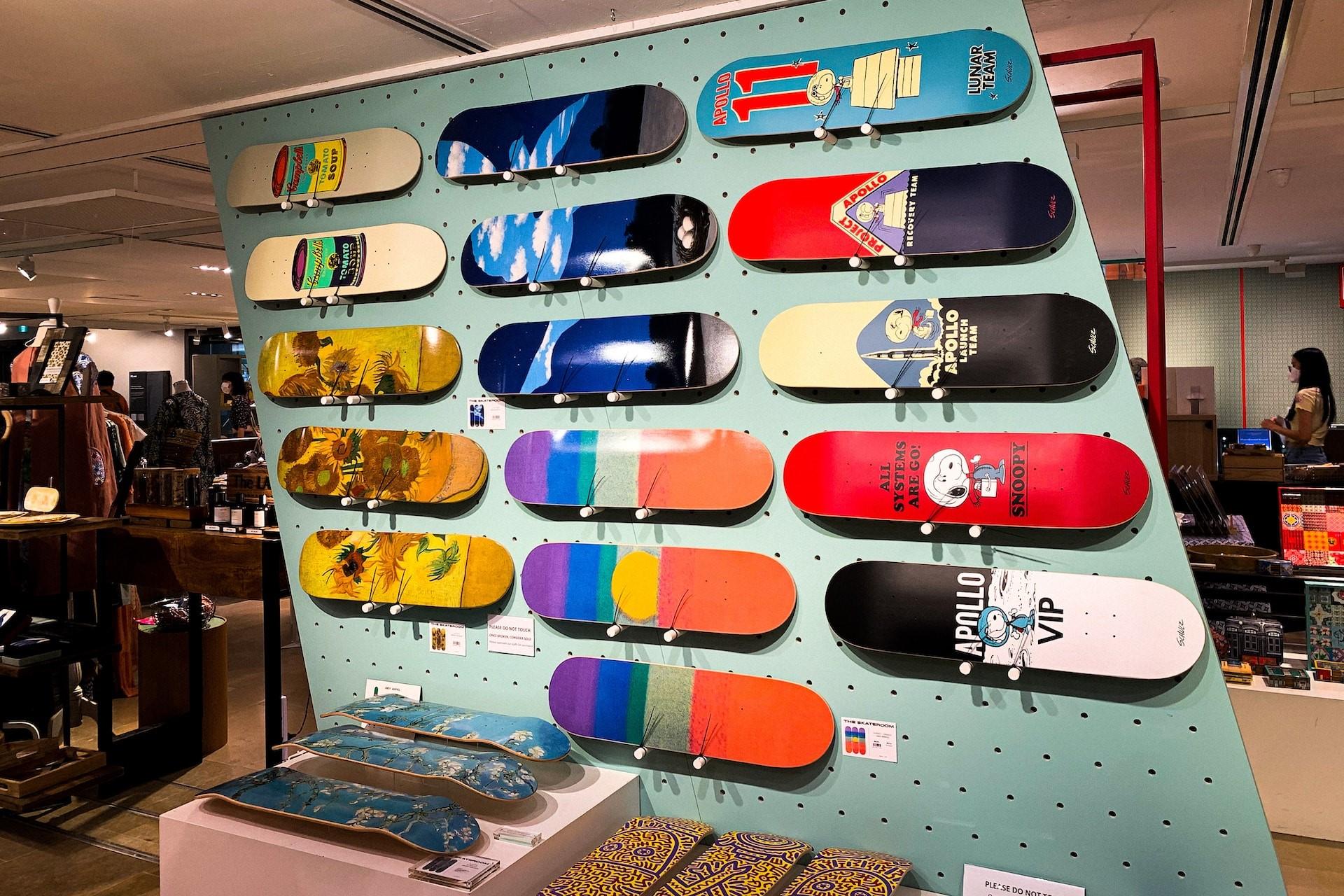 A wall display of skateboard decks in a skate shop.