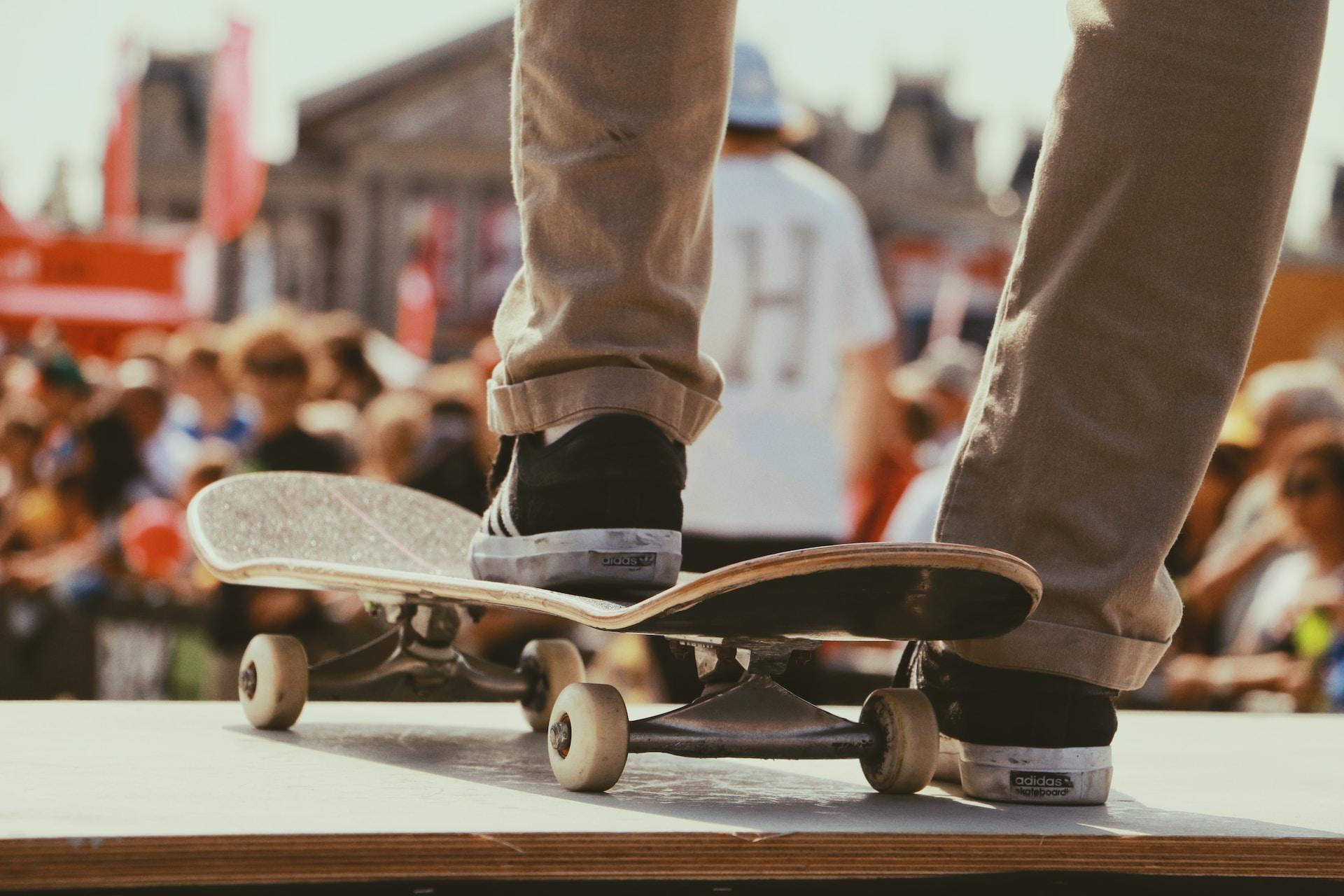 A skateboarder at the top of a ramp or pipe.