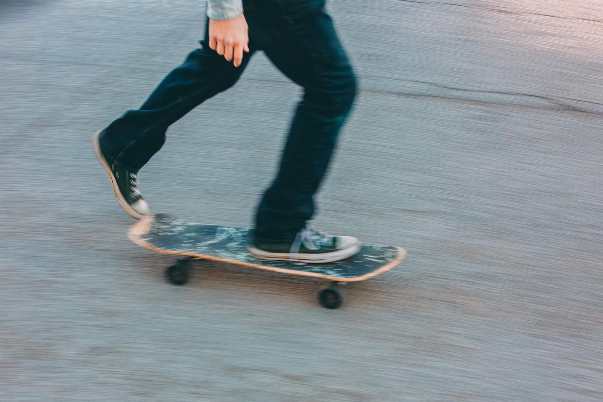 A skateboarder pushing off with his foot.