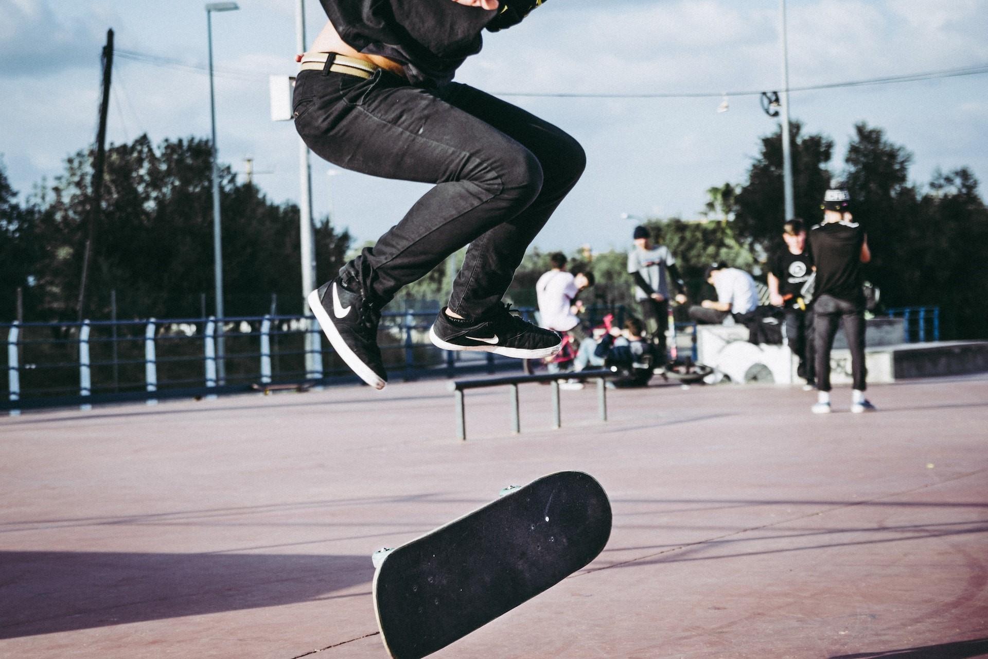 A skateboarder doing a trick in a skatepark.