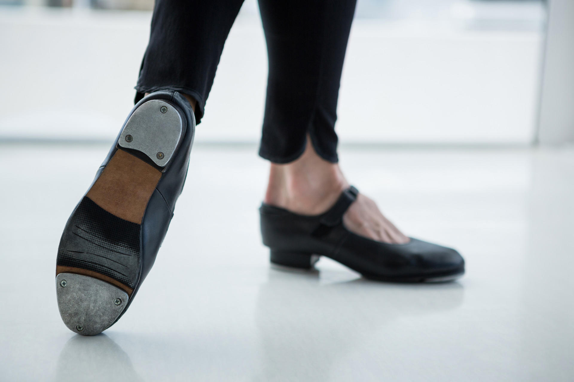 Shiny black tap dancing shoes.