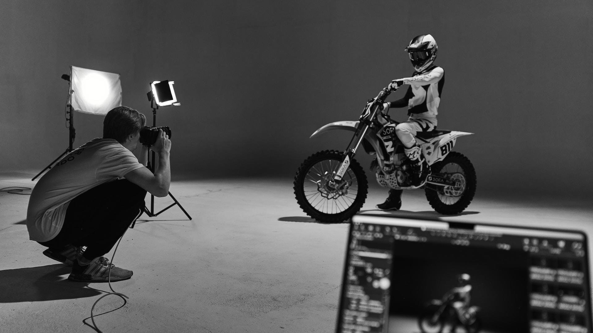 Balack and white photo of a person on a motorcycle.