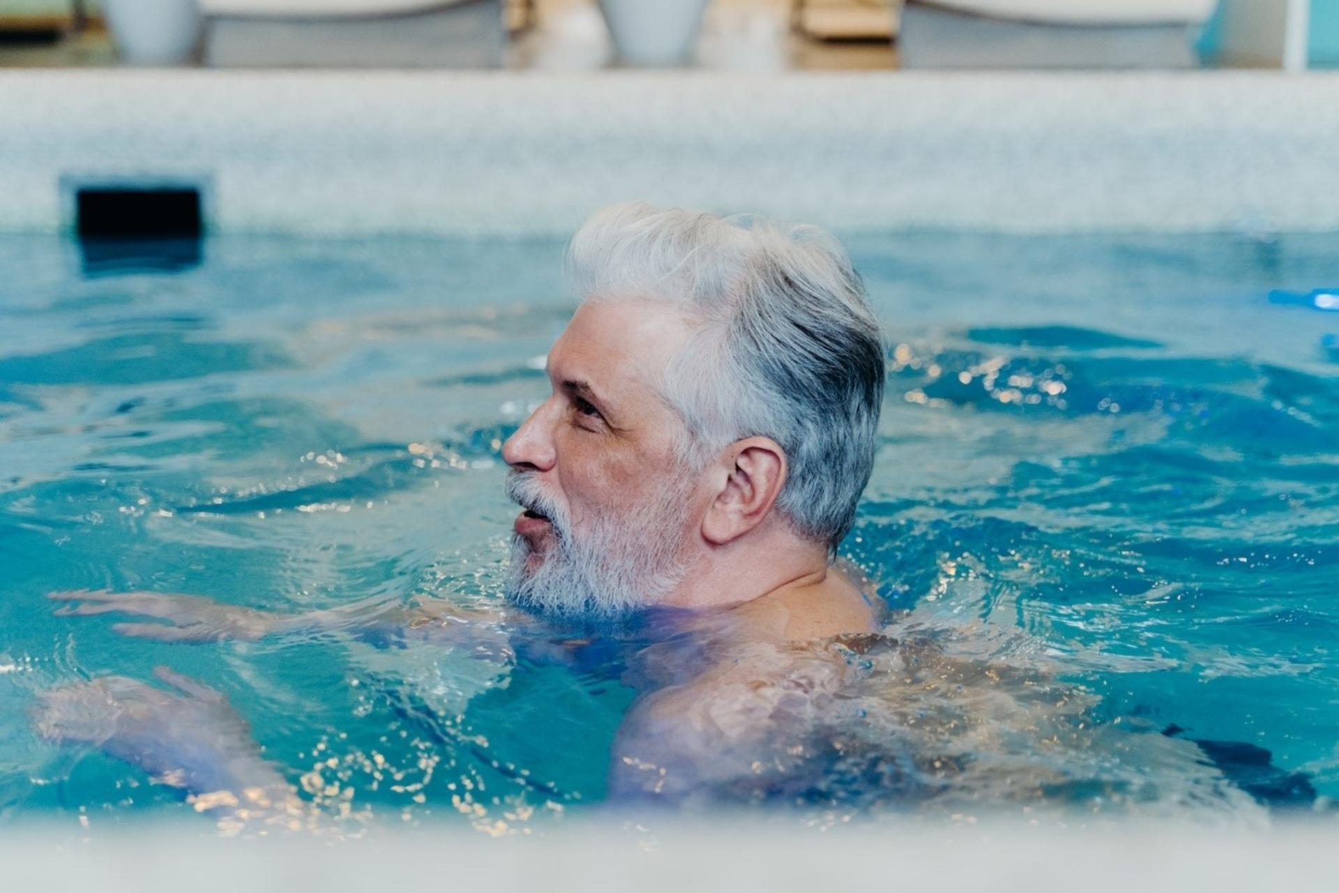 Elderly man in the swimming pool 