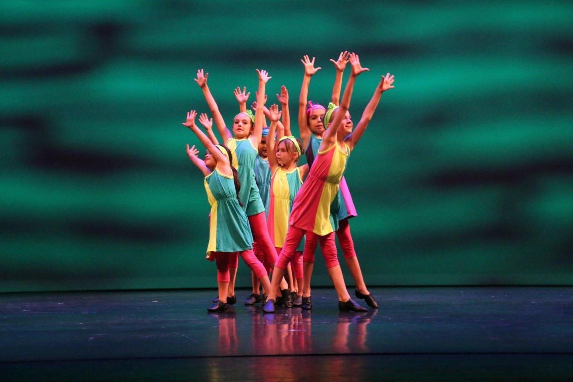 Group of young tap dancers performing.Kids will love tap dancing moves since it's a fun way for them to express themselves through rhythm and movement.