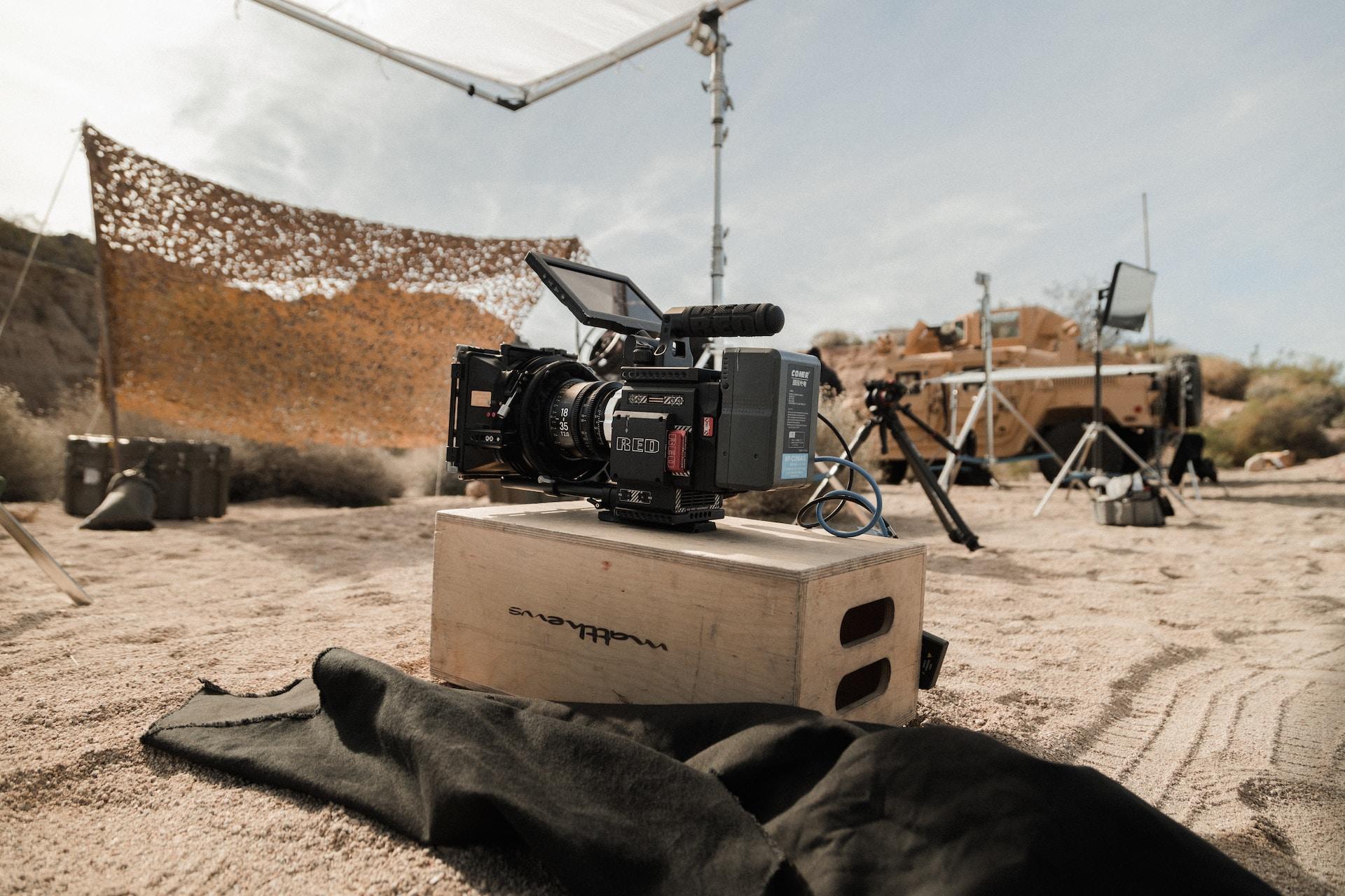 A recording site with a camera on top of an apple box.