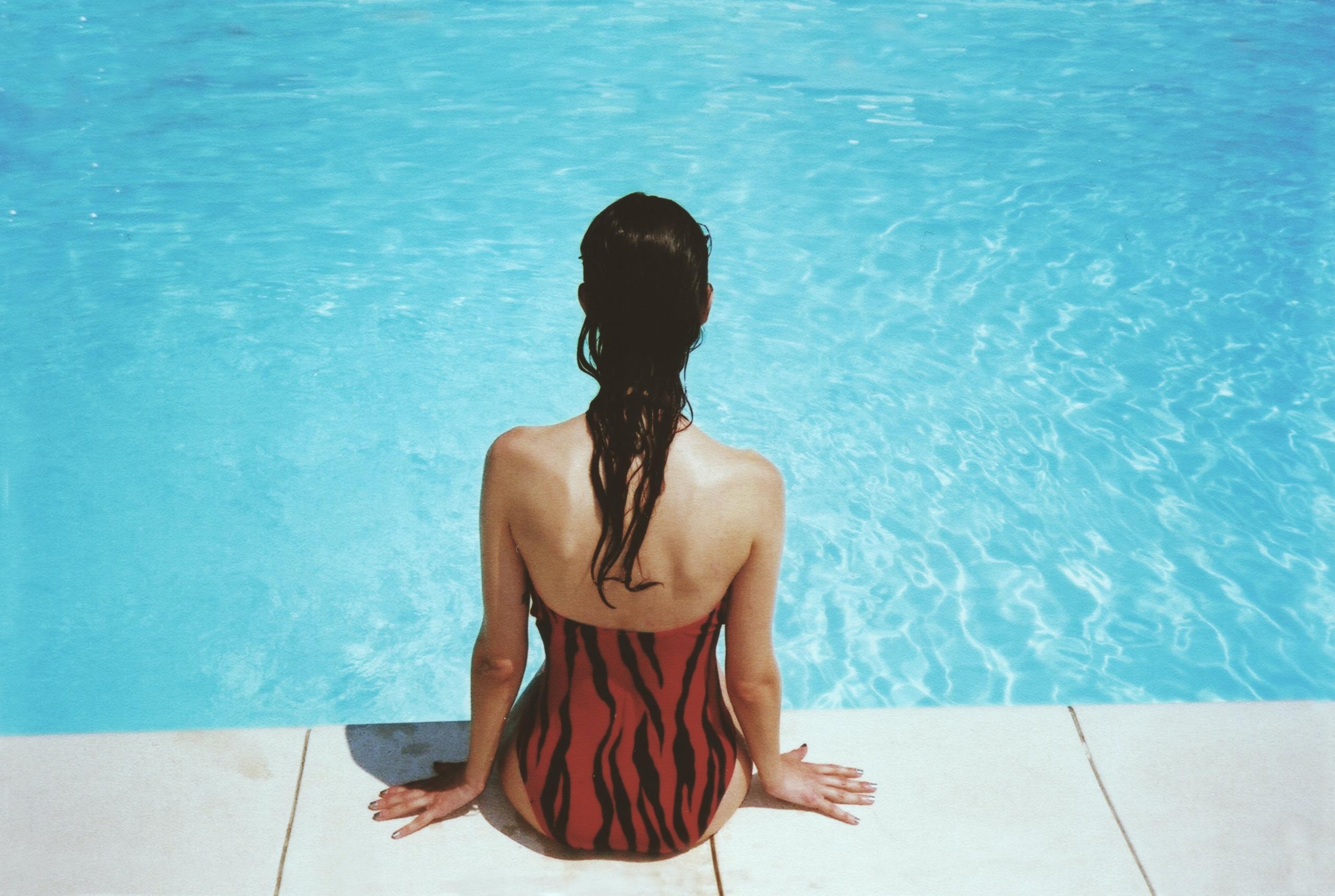 Women relaxing and resting by the pool.