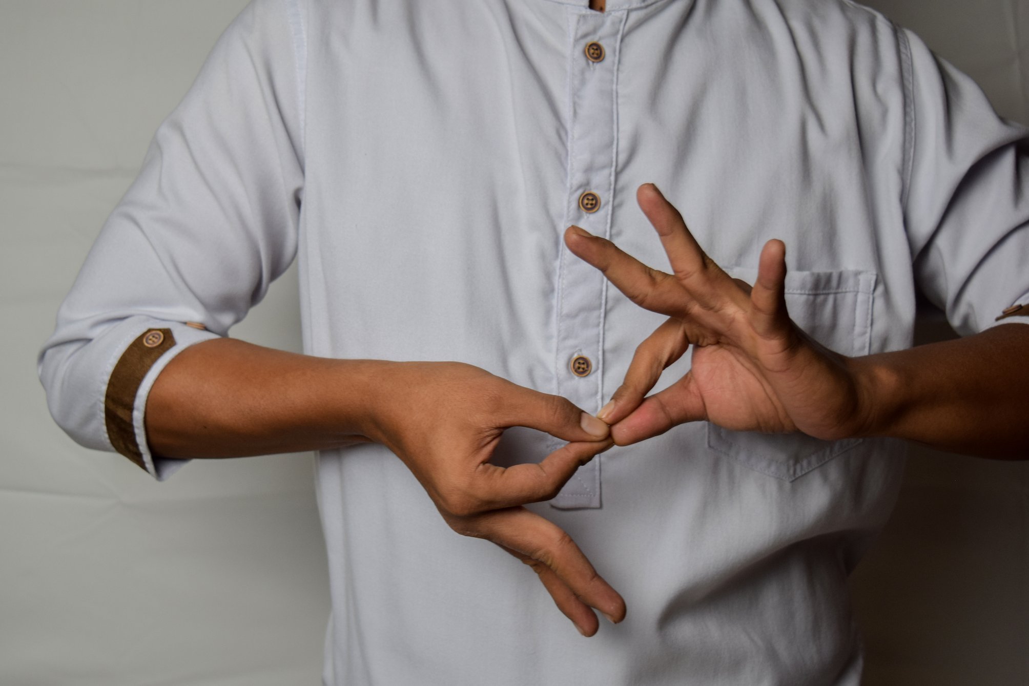 Close up of hands signing.