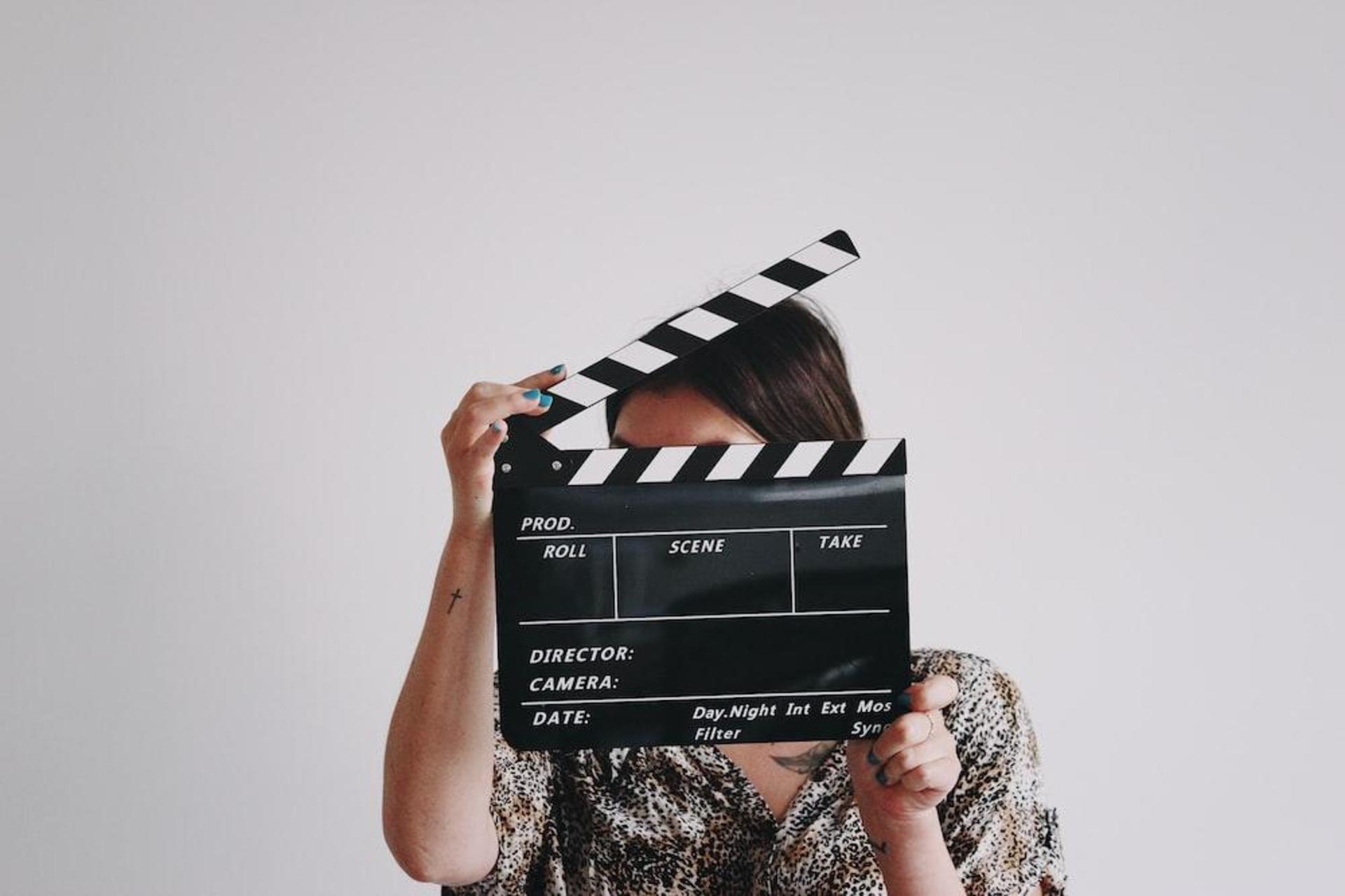 A woman holding a clapper.