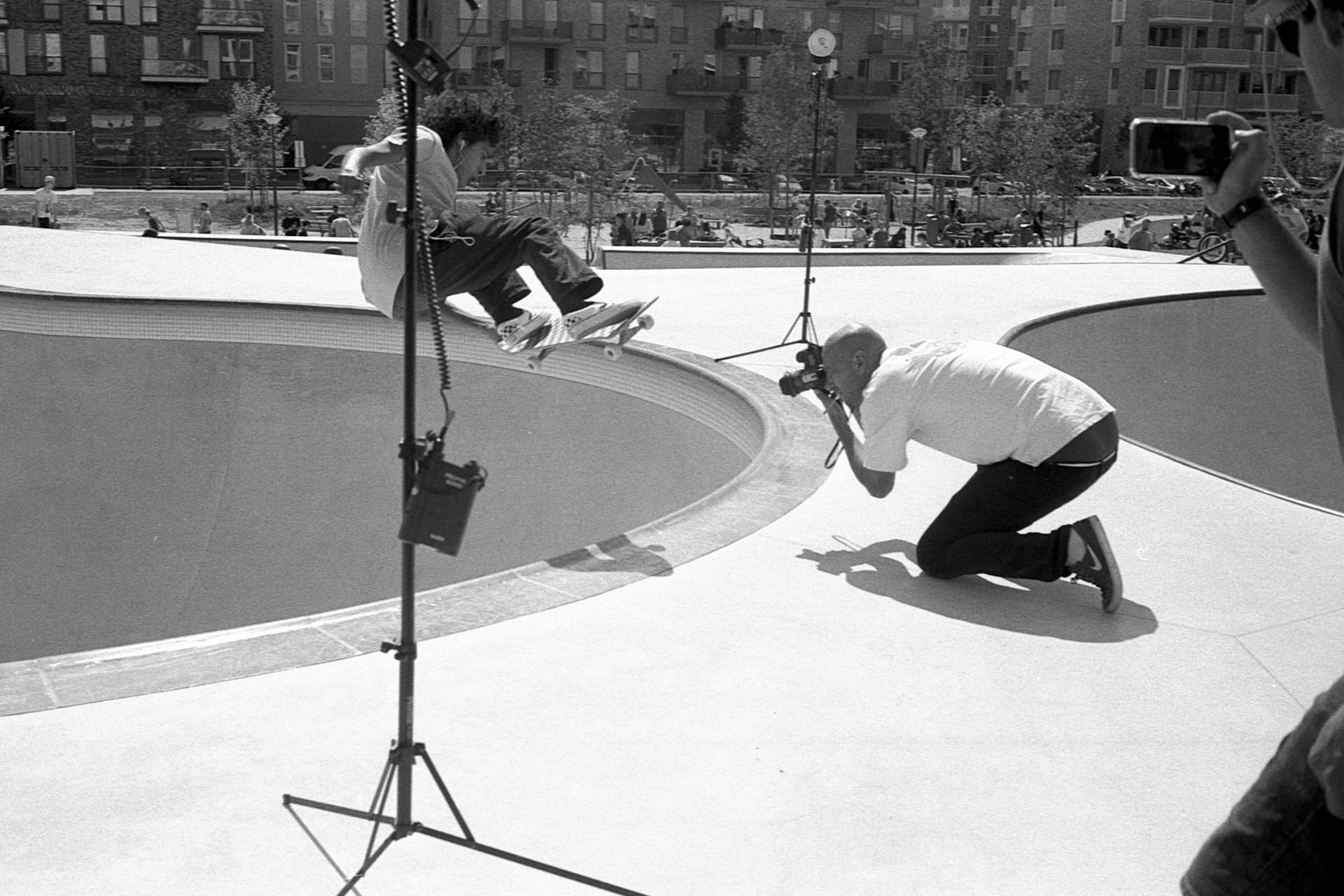 Cameraman photographing a skateboarder.