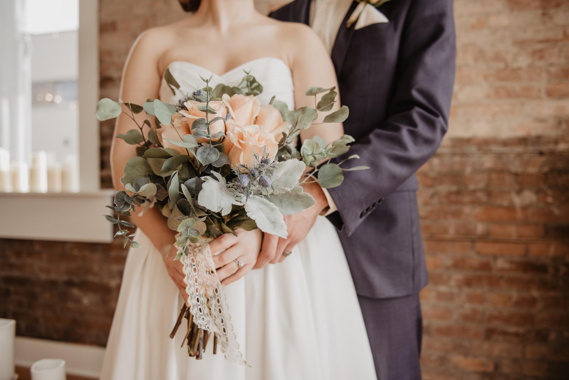 Wedding portrait of the bride and groom and the bouquet.