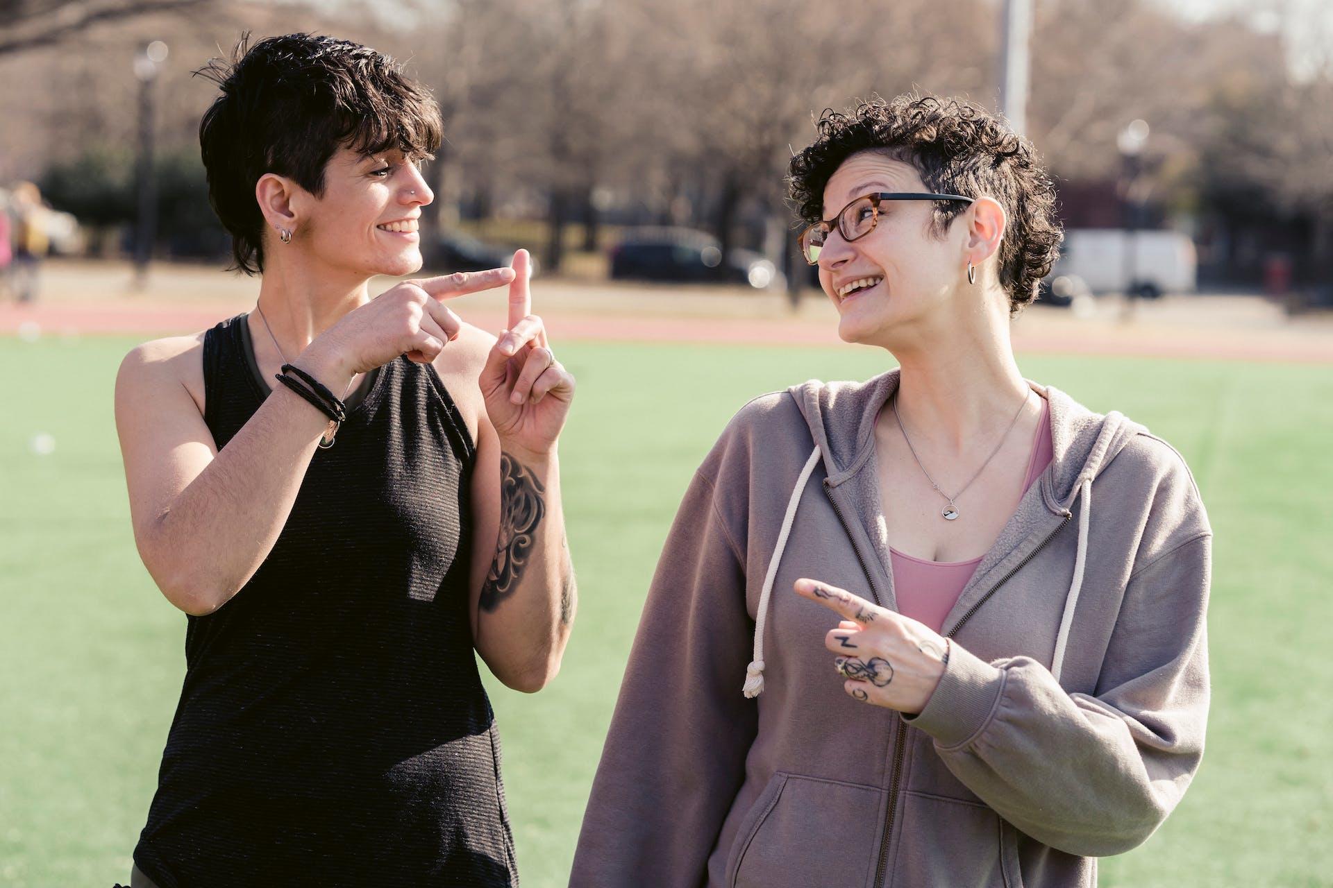 Two girls communicating in sign language.