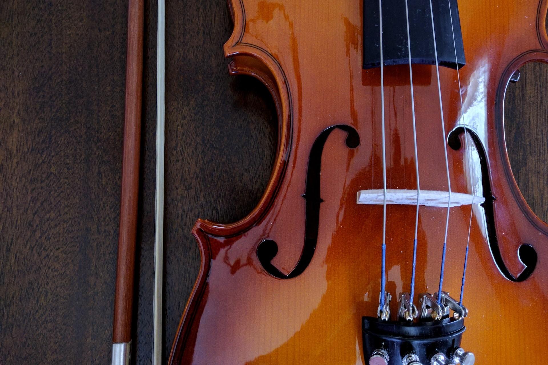 A closeup of a violin and a bow.