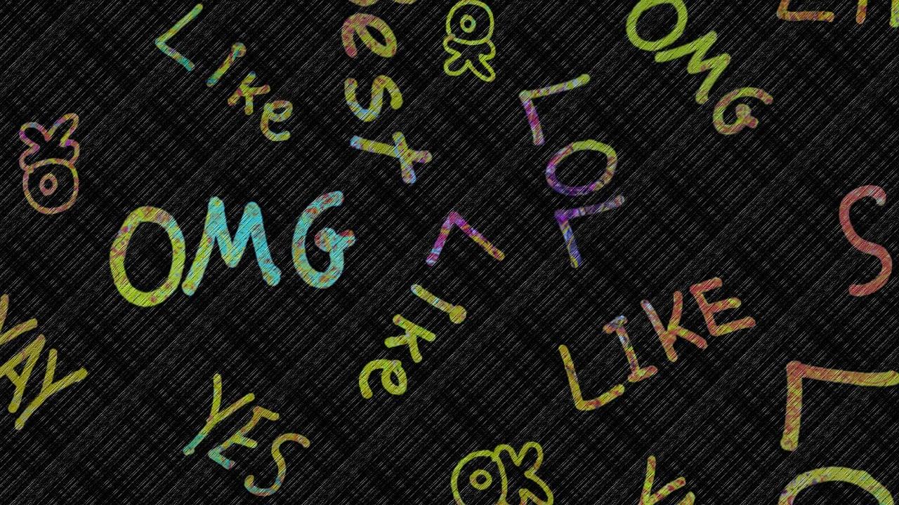abbreviations written out in coloured font on a board including 'LOL' and 'OMG'